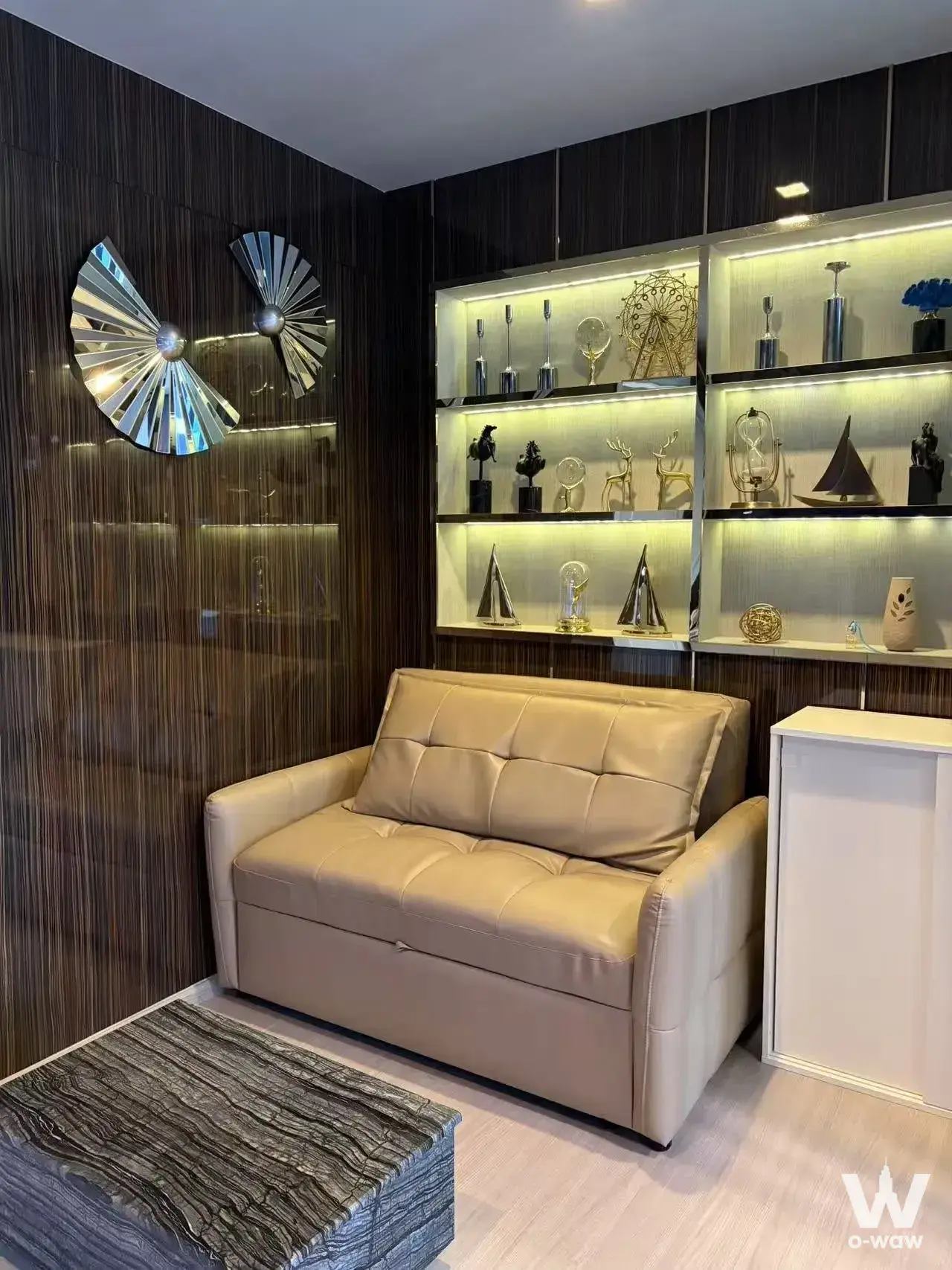 Modern 1-bed condo living room in Life Asoke with dark wood-slat feature wall and gold accents