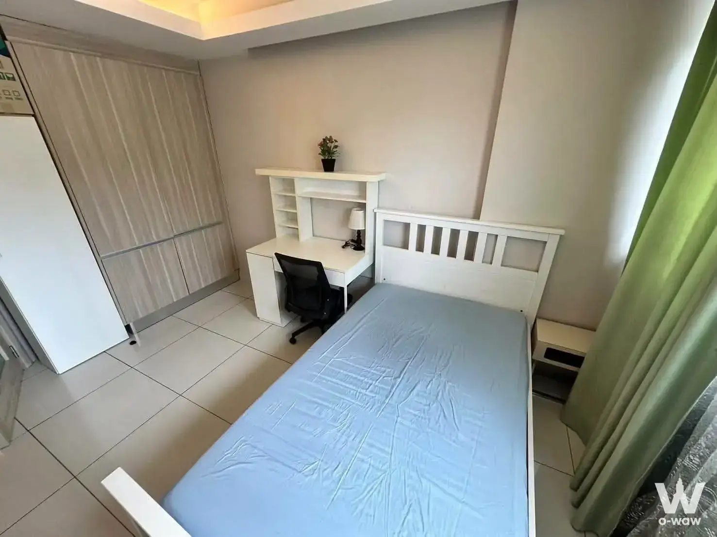 2-bed condo bedroom in Laguna Beach Resort 1 with white bed, light wood wardrobe, and desk hutch