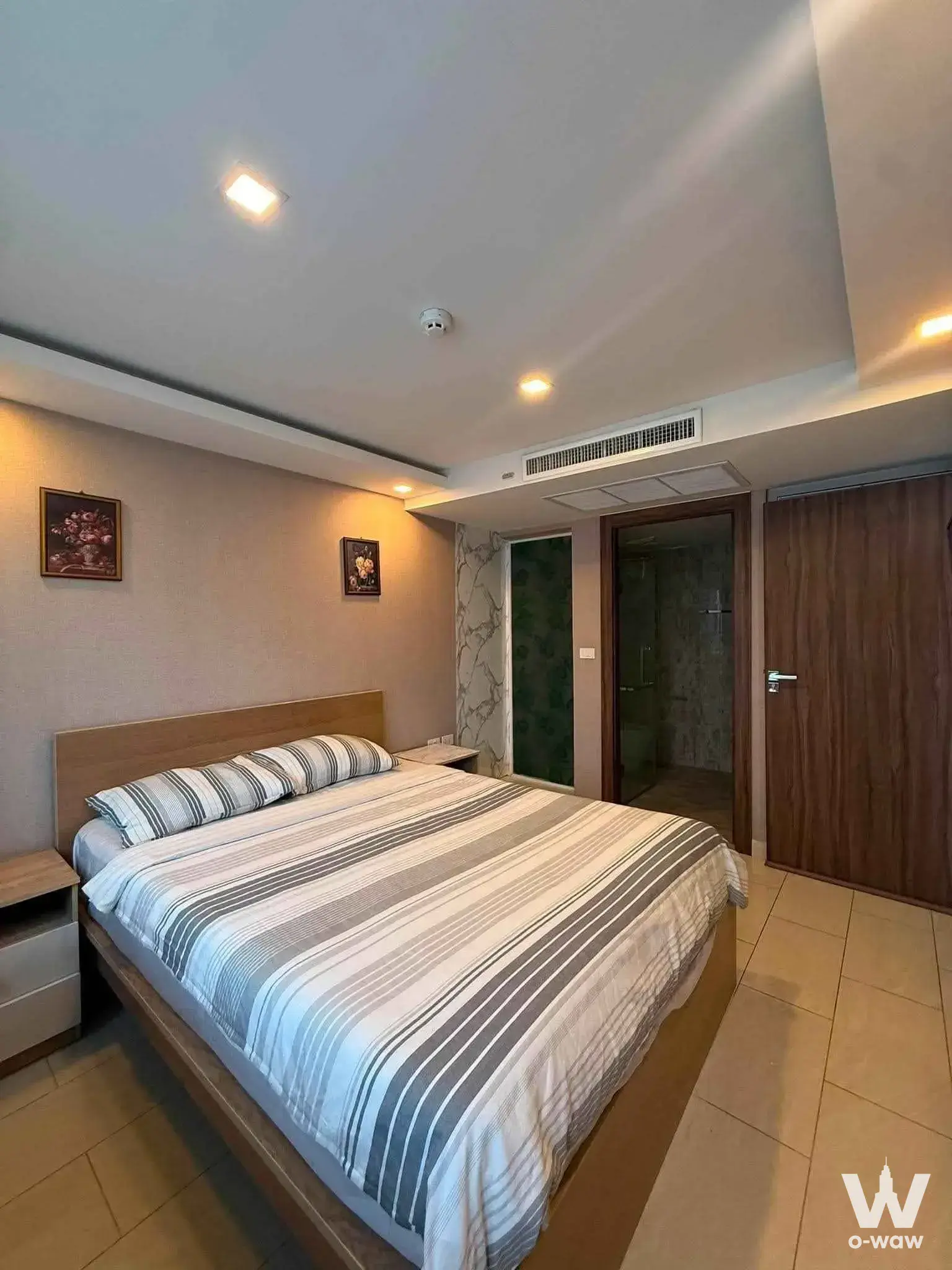 1-bed condo bedroom in Grand Avenue Residence with wood accents
