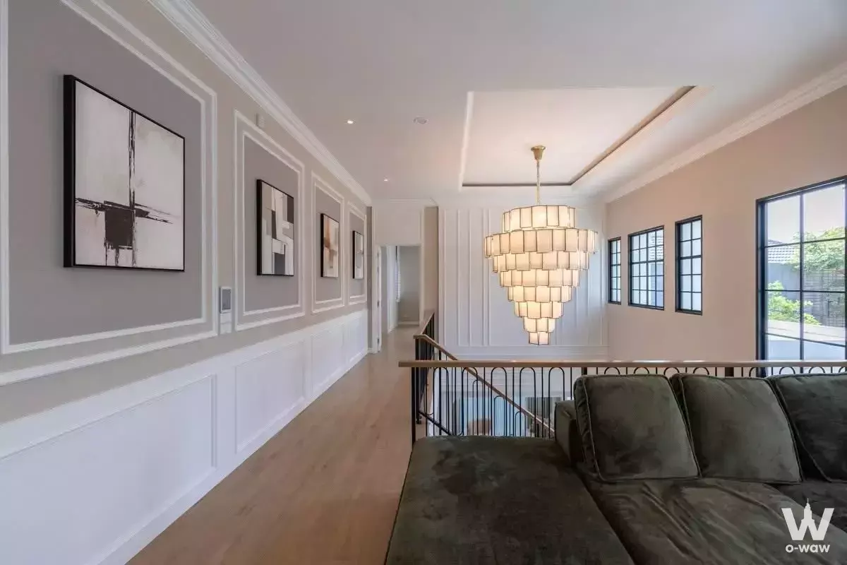 Loft living area in Narinsiri Rama 9 house with chandelier and void railing