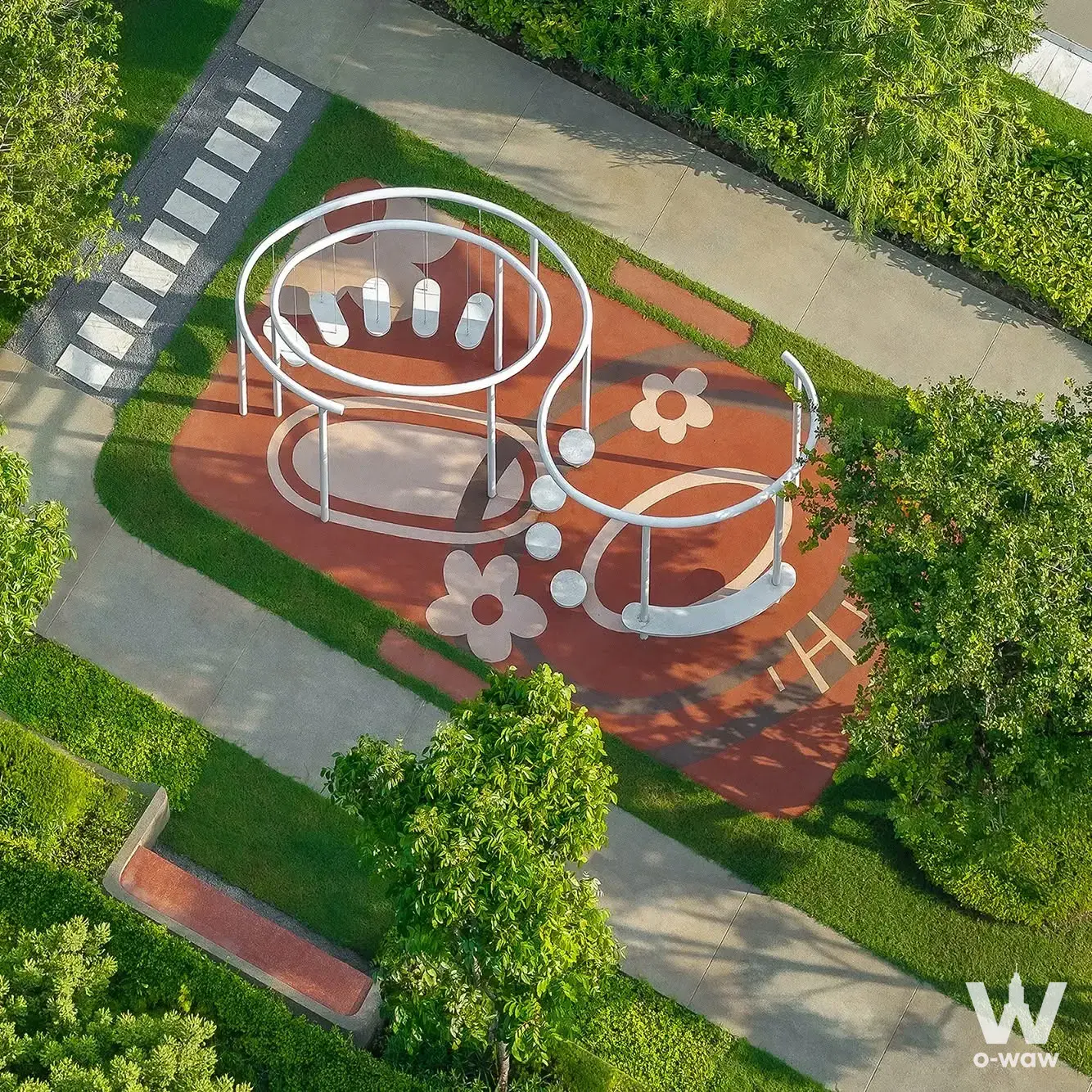 Aerial view of a red-surfaced playground with a white circular swing set at a Nova Westgate 4-bed house