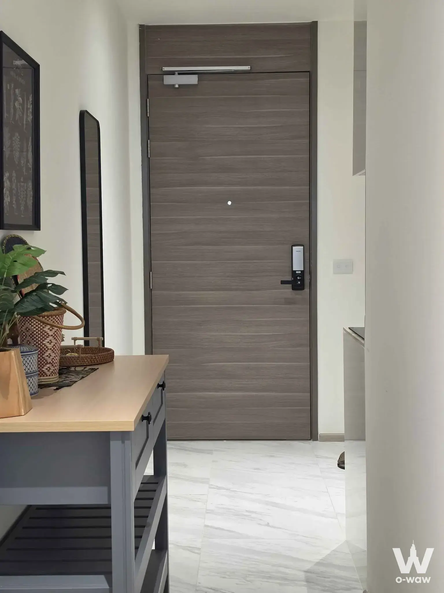 Modern entryway with smart lock and console table in a 2-bed condo for rent in Fynn Asoke
