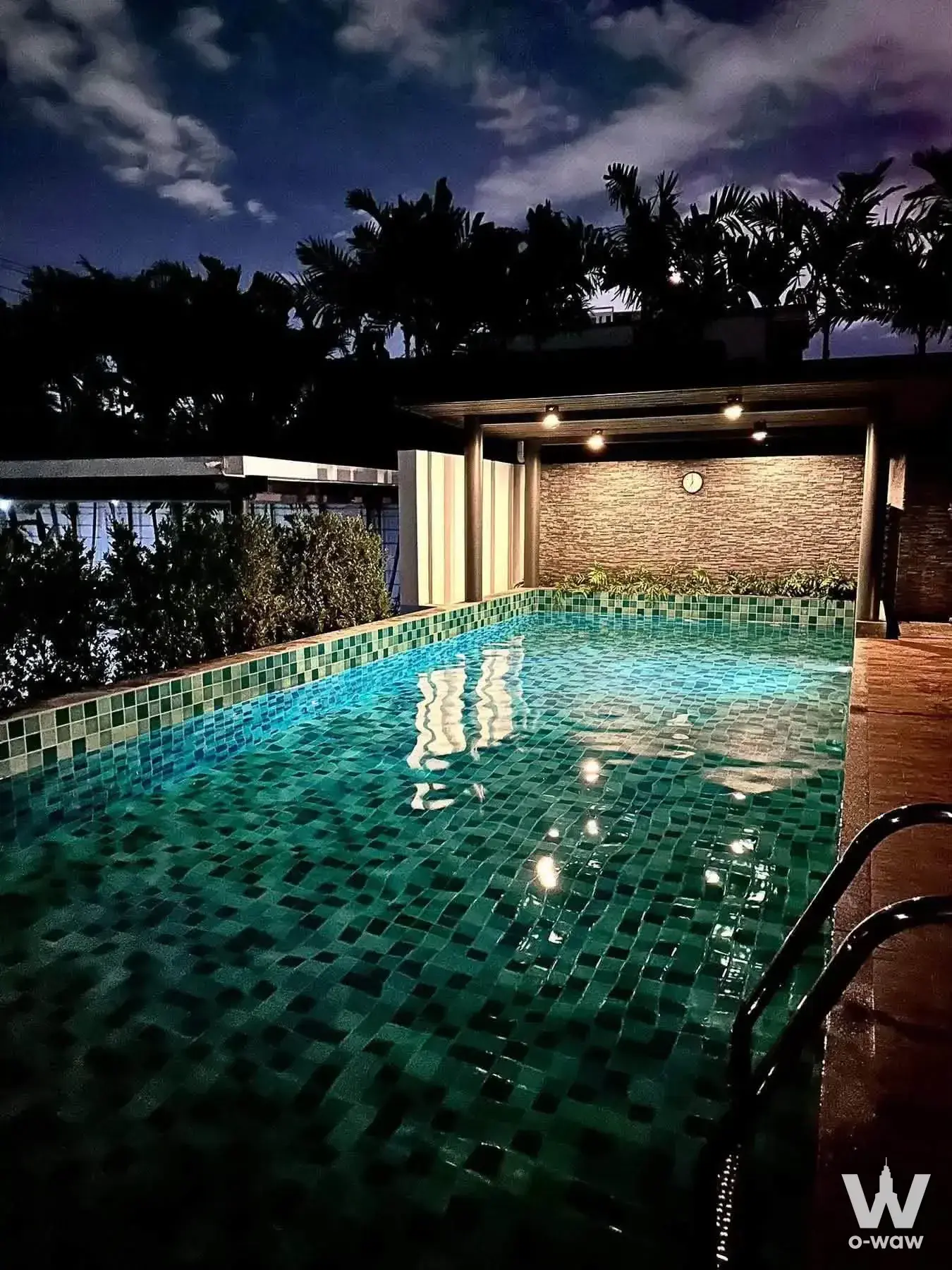 D-50 private apartment pool at night with teal mosaic tiles and warm lighting