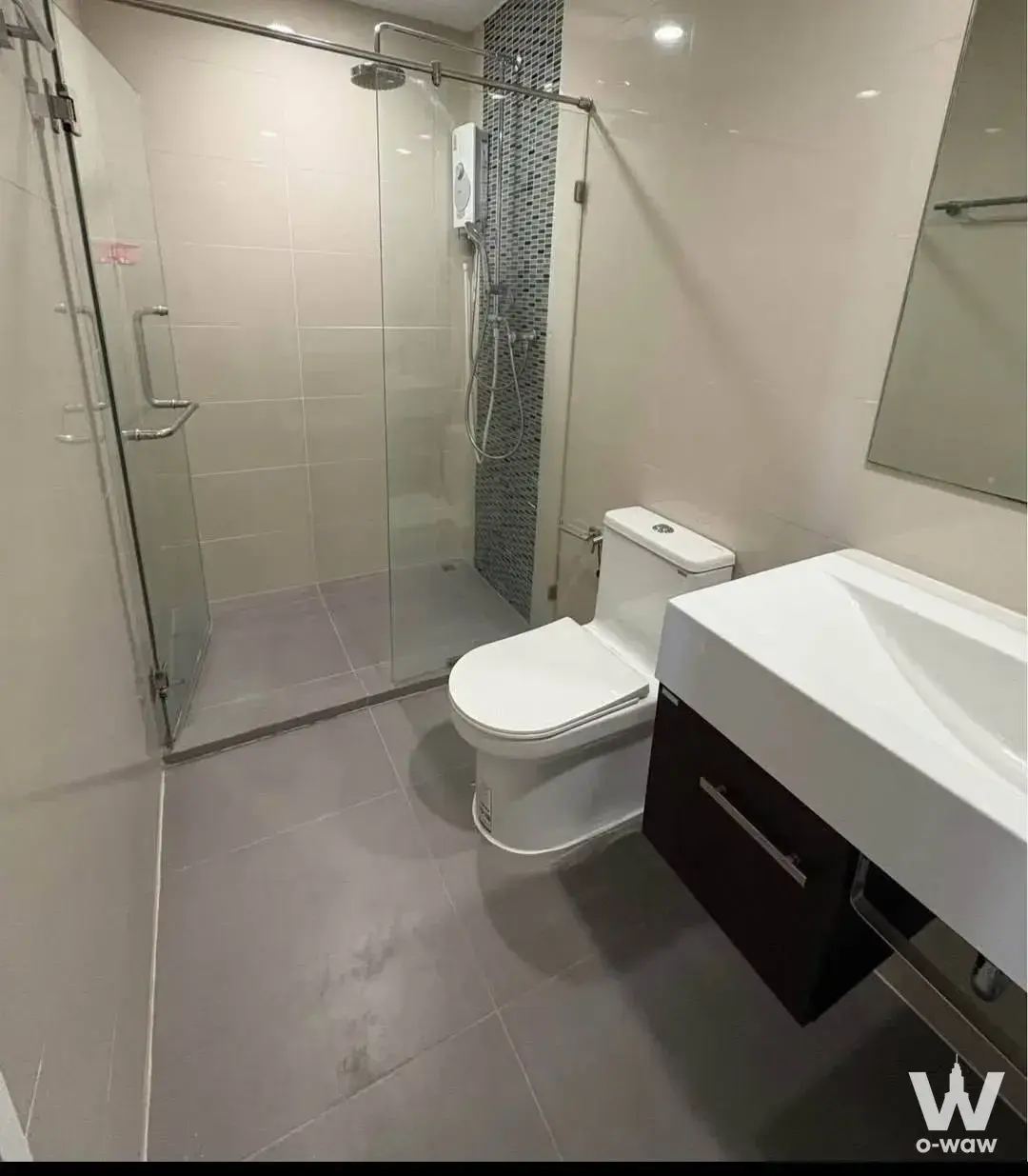 Modern bathroom with glass shower enclosure and floating vanity in The Sky Sukhumvit