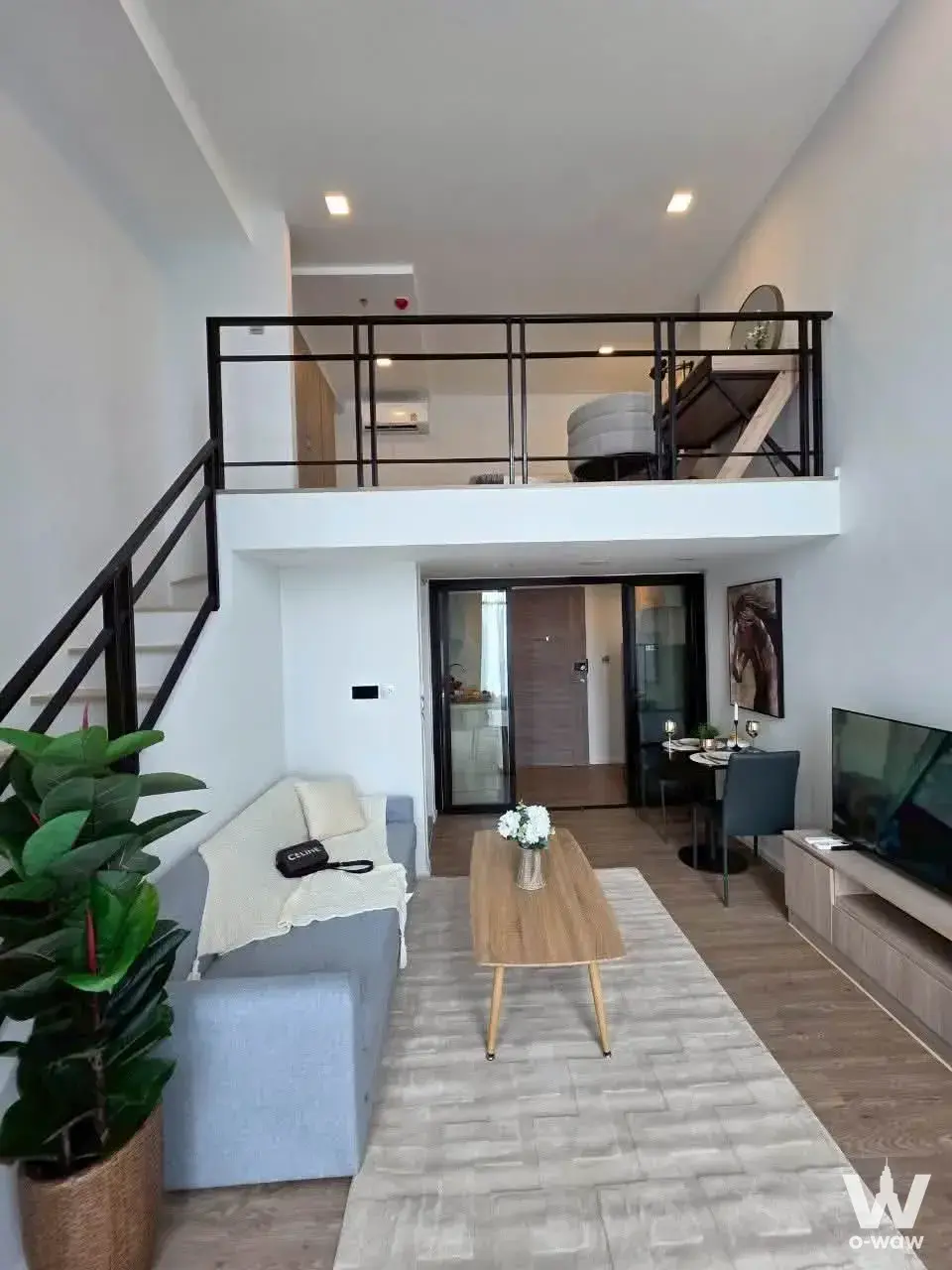 Loft-style condo at Modiz Sukhumvit 50 with double-height ceilings, mezzanine level, and modern furnishings