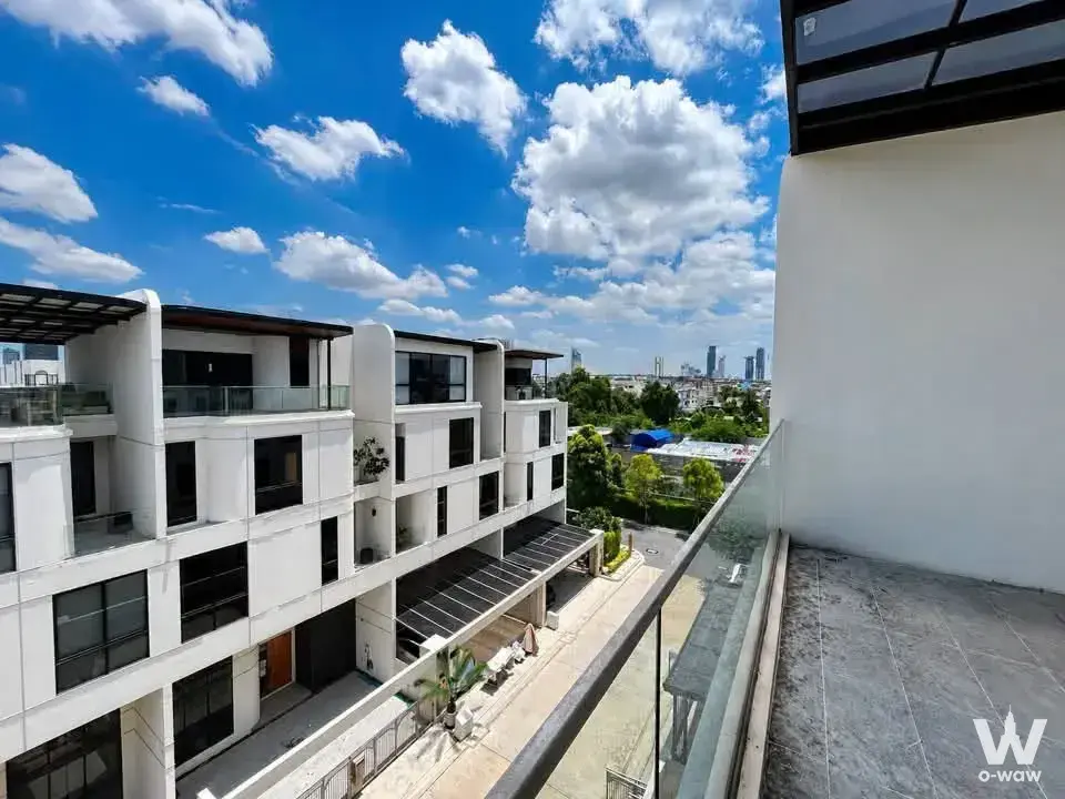 Balcony exterior of a 3-bed house in DEMI Sathu 49 with stone tile flooring and black metal pergola
