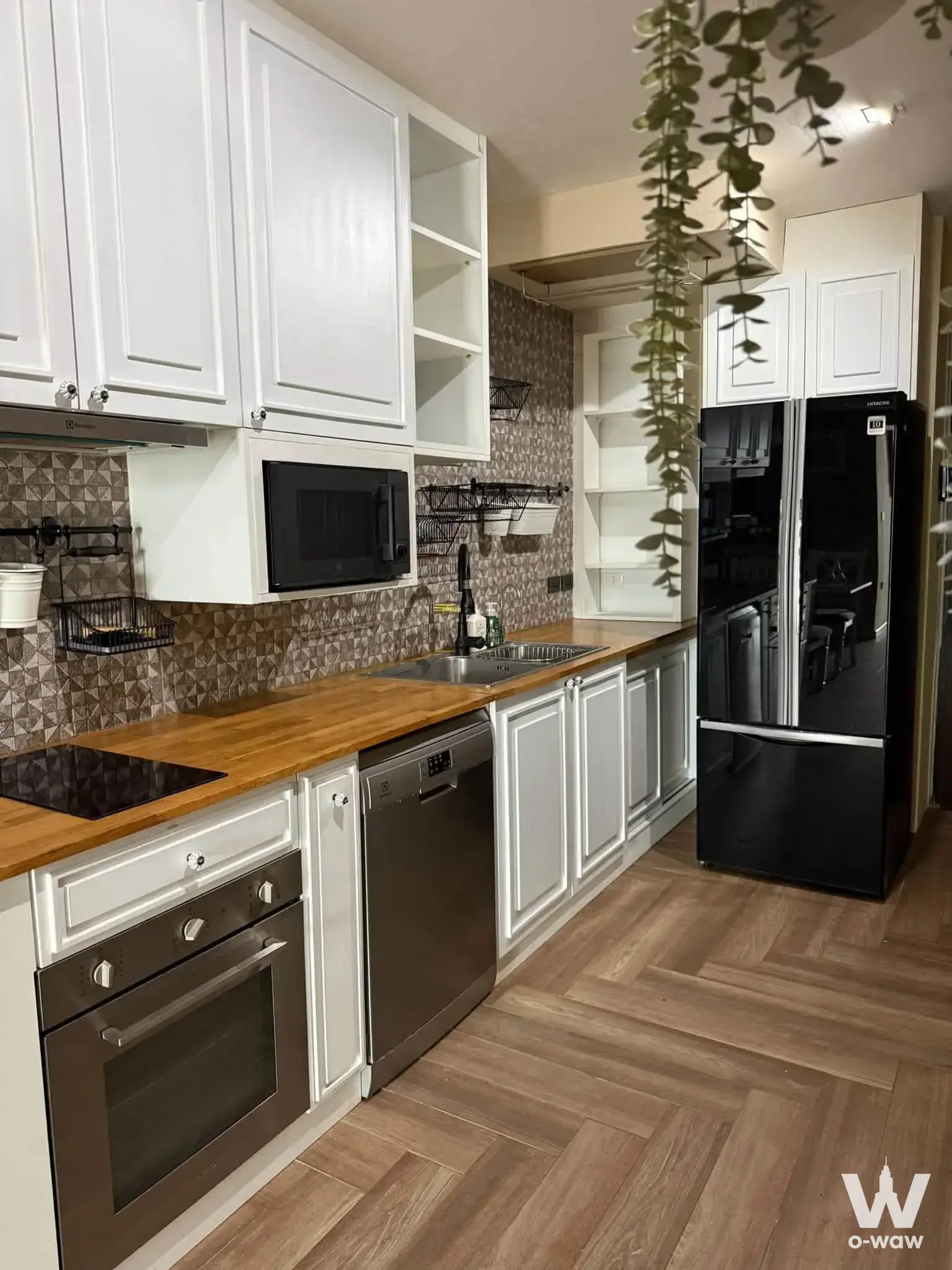 Fully equipped modern kitchen in The Alcove Thonglor 10 with butcher-block counter and stainless steel appliances