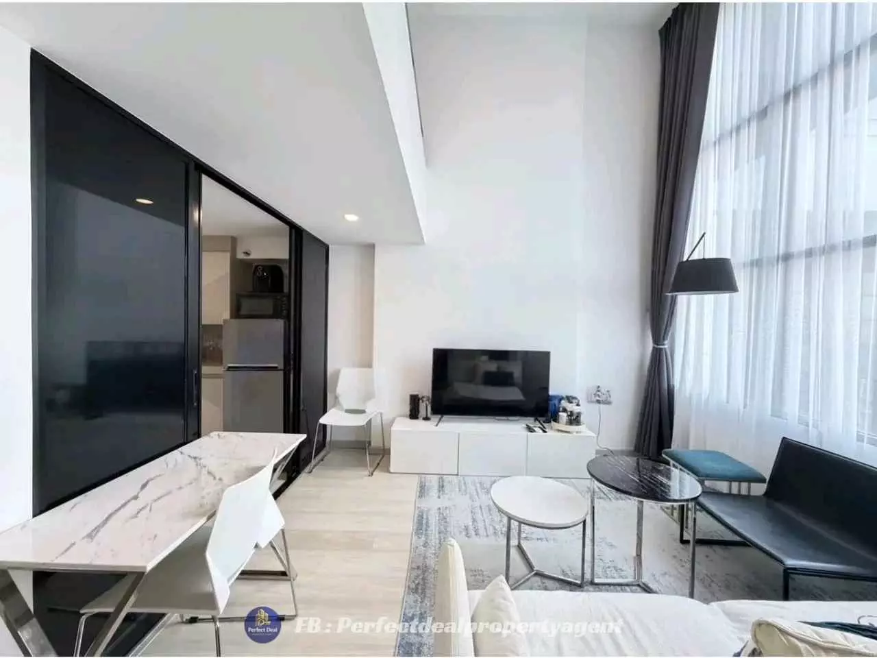 Open-plan living and dining area in KnightsBridge Prime Sathon with marble table