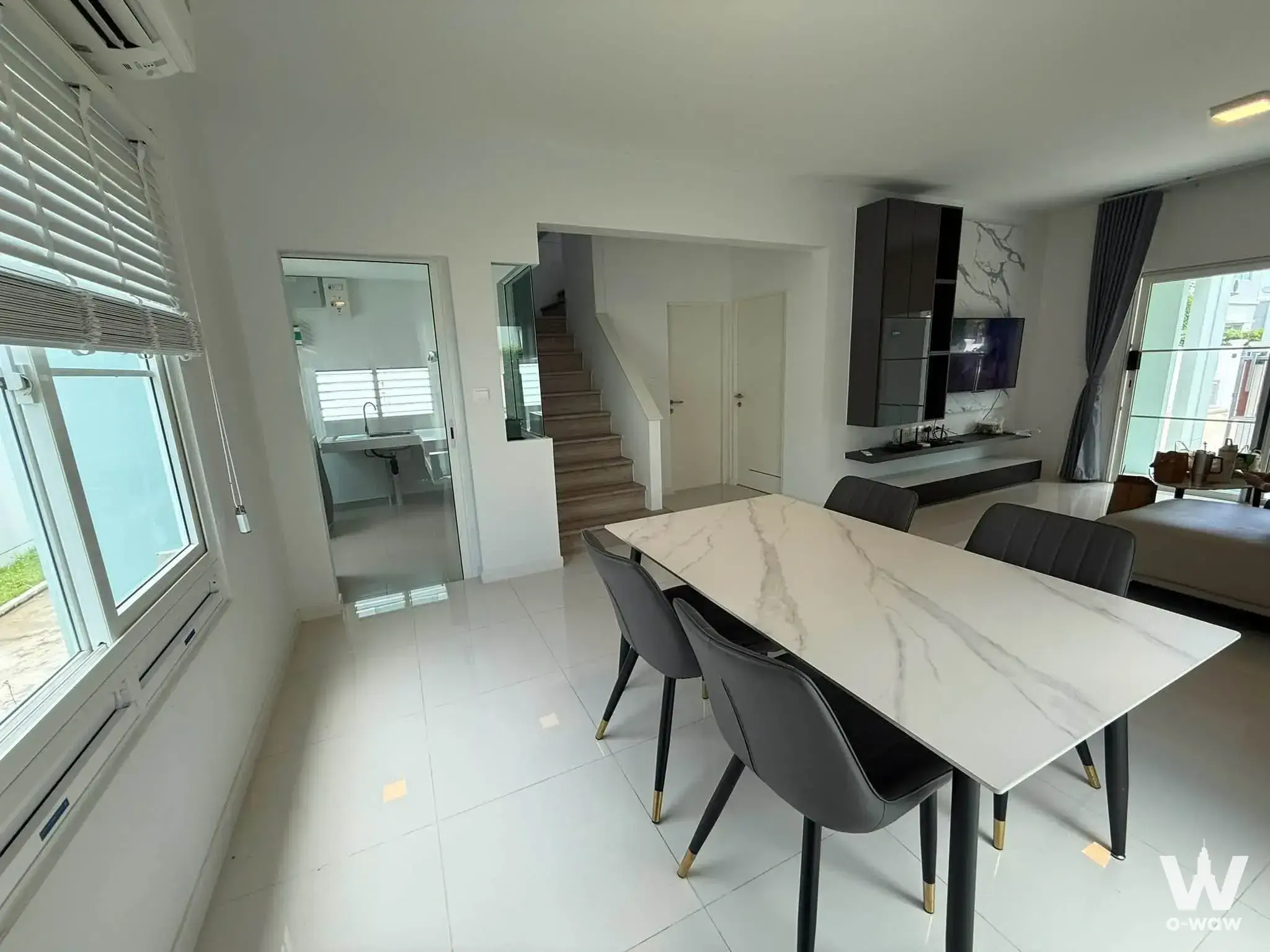 Grey dining chairs and marble table in a 3-bed house for rent in Villaggio 2 Srinakarin-Bangna