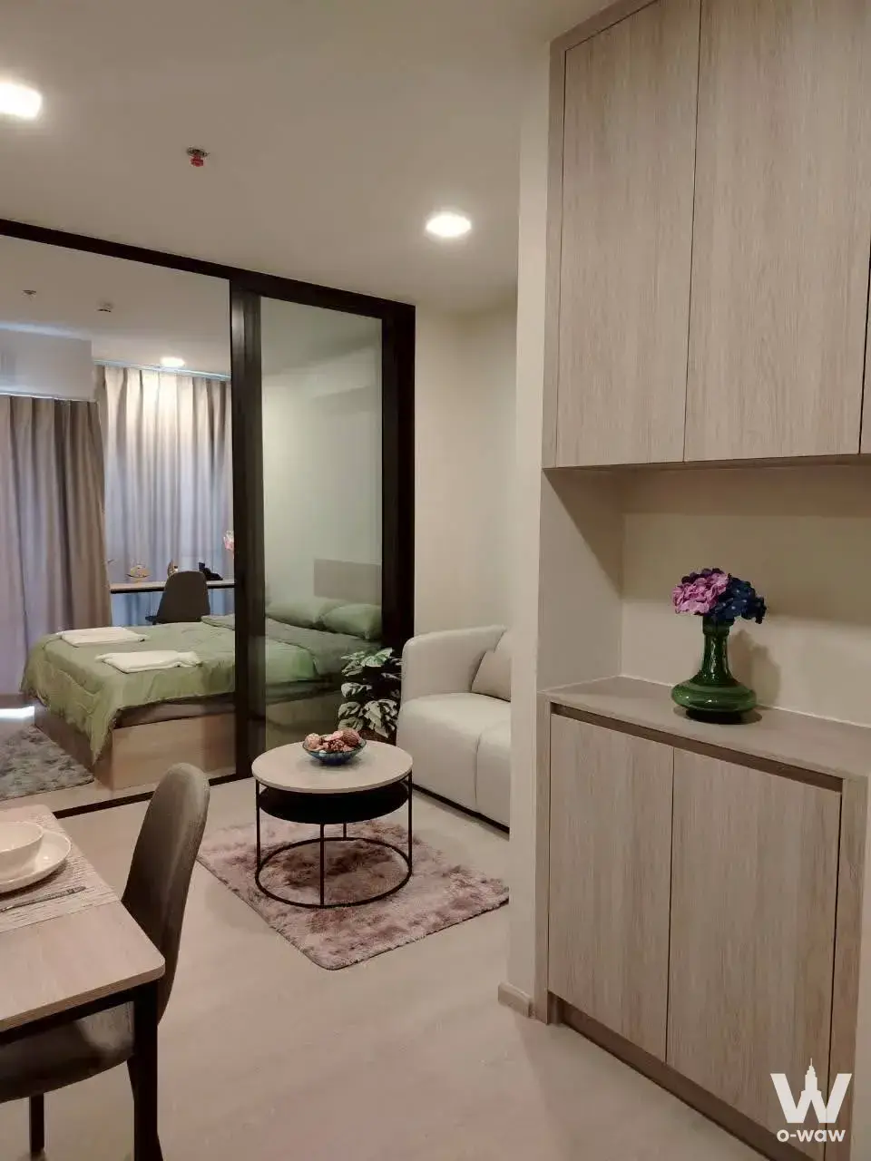 FLO by Sansiri 1-bed condo open plan living and dining area with modern furniture