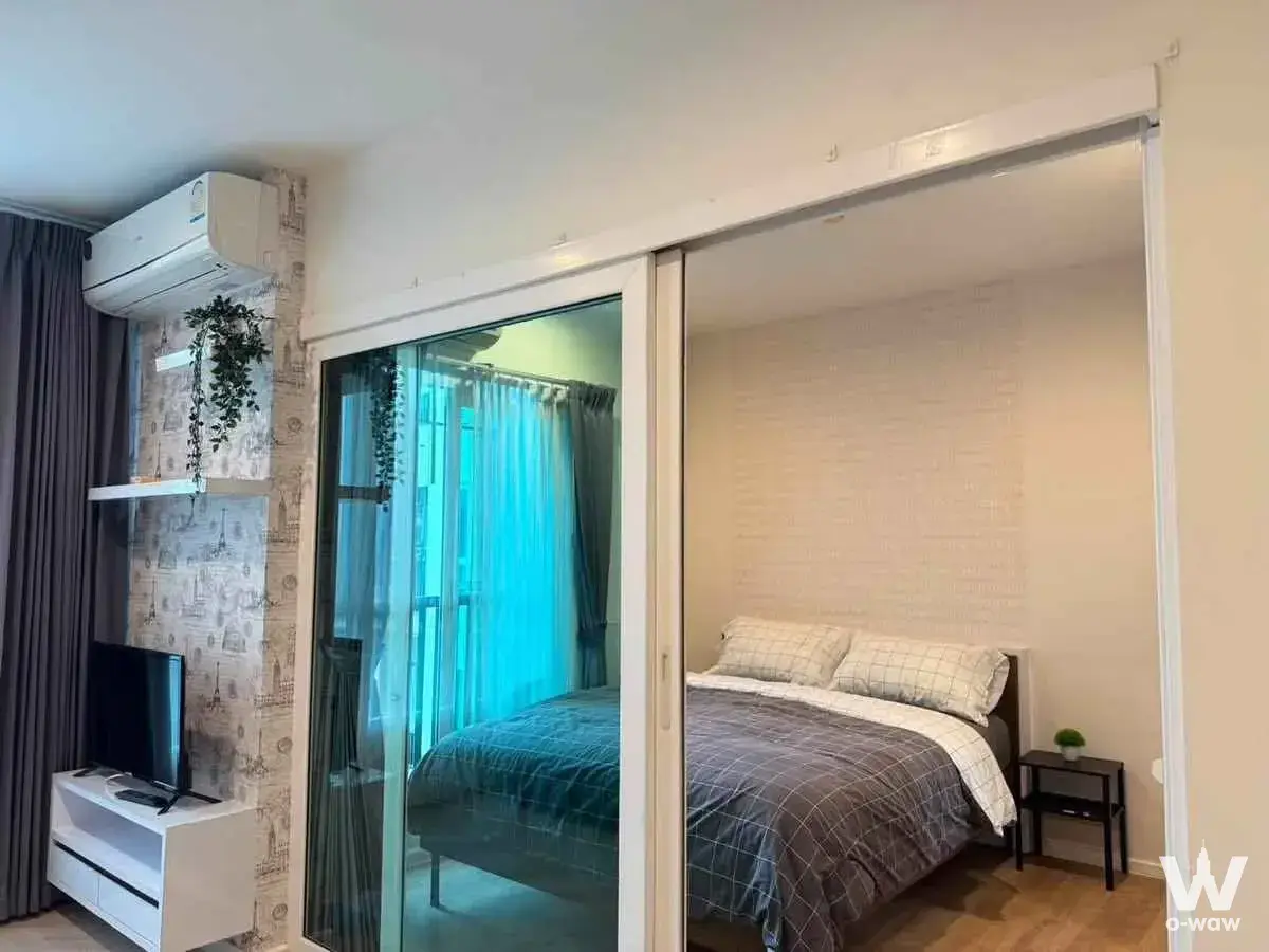 The Key Sathon 1-bed condo studio with Paris wallpaper, floating shelves, and TV