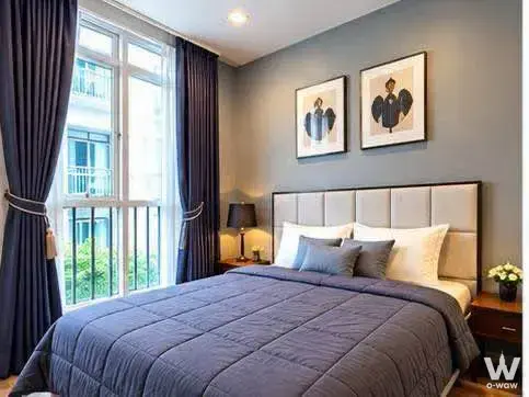 Master bedroom with navy drapes and city view in Maestro 01 Sathorn-Yenakat
