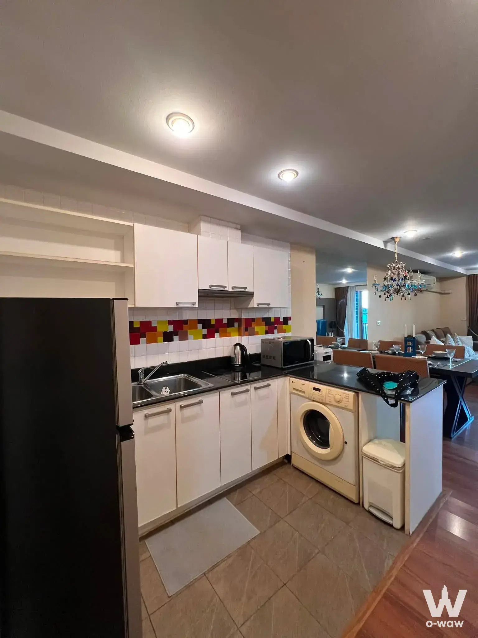2-bed condo for rent in Centric Place with mosaic tile backsplash and glass dining table