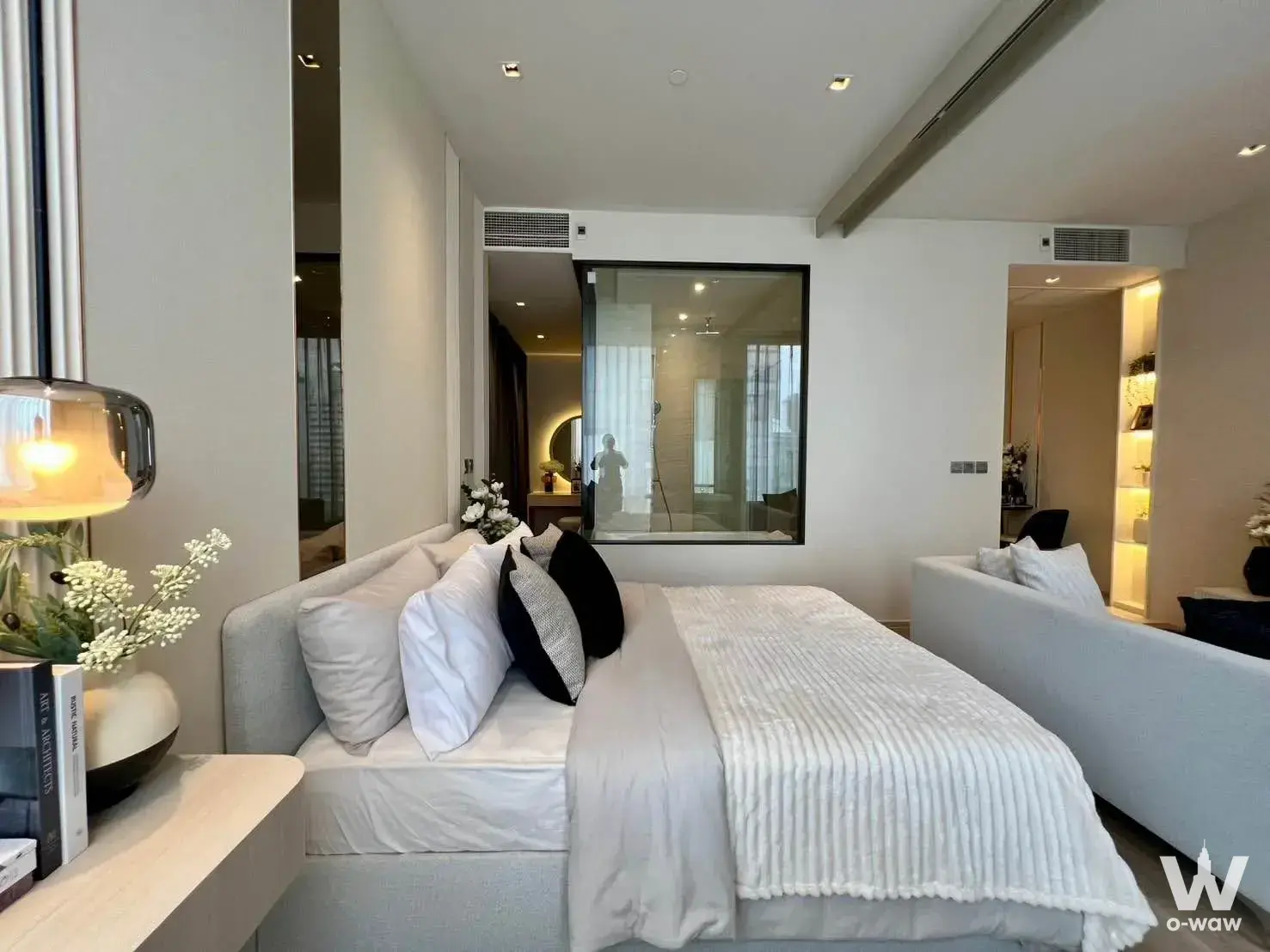 King bed with en-suite bathroom view in a luxury 1-bed condo for sale at Ashton Silom