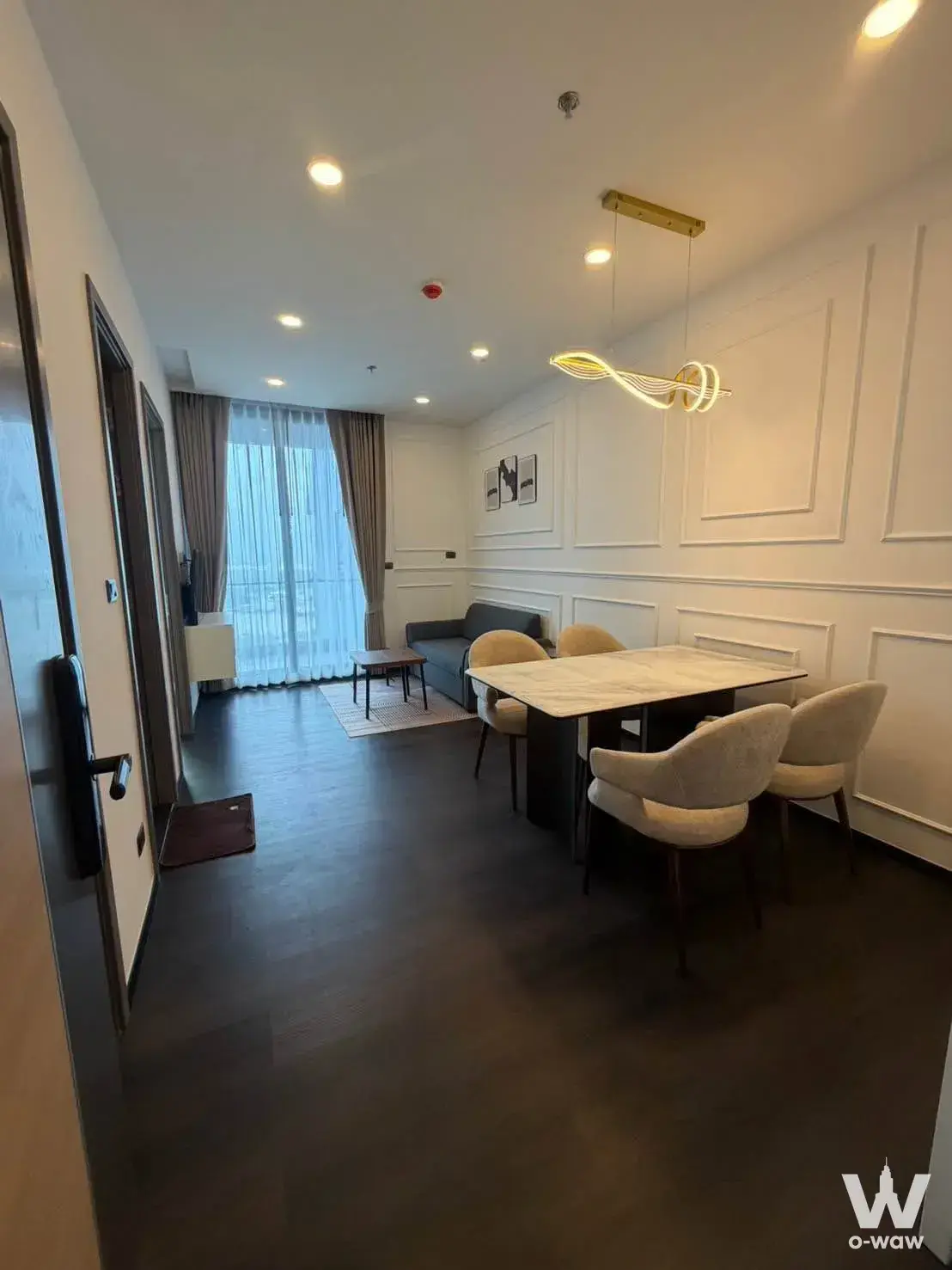 Sapphire Condominium 1-bed open-plan living and dining space with marble table and wood floors