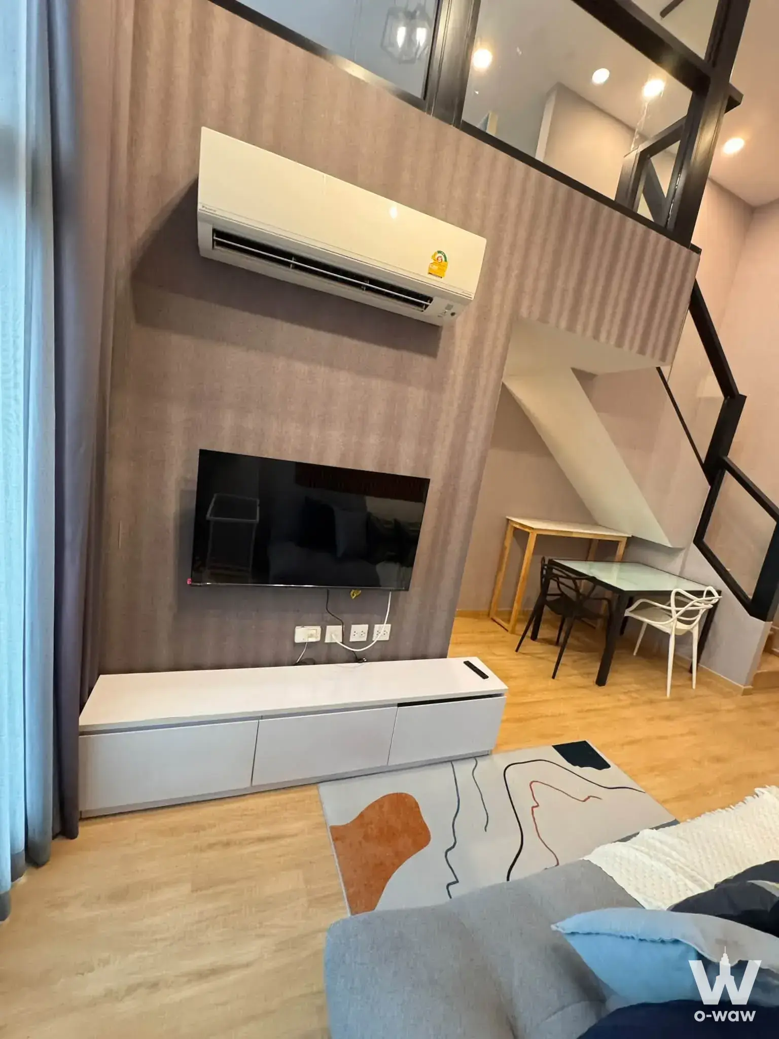 Loft studio mezzanine with wood paneling, TV, and dining nook in The Tree Sukhumvit 71-Ekamai