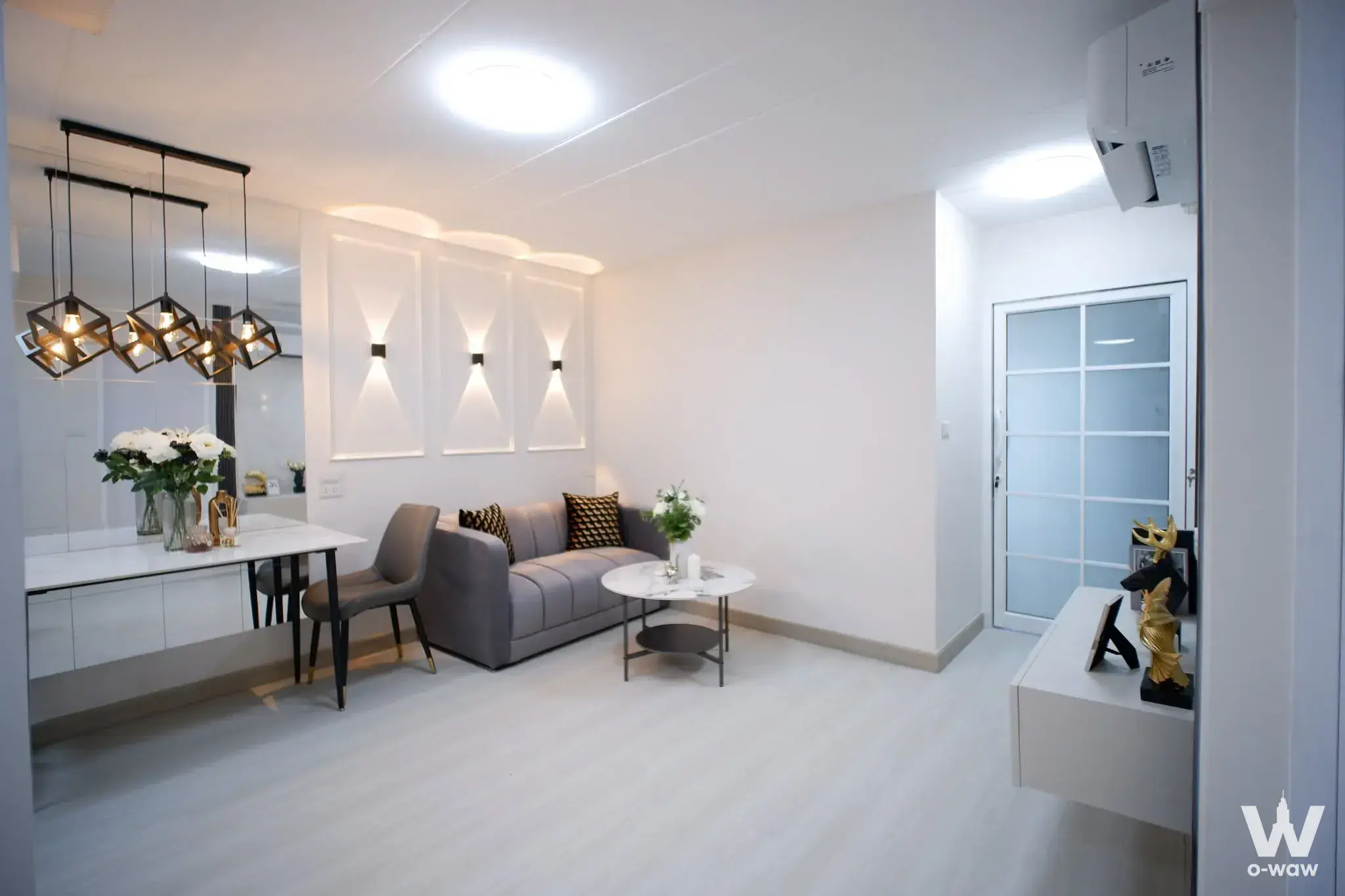 Thana Place 45A 2-bed condo modern living and dining area with marble coffee table and gold accents