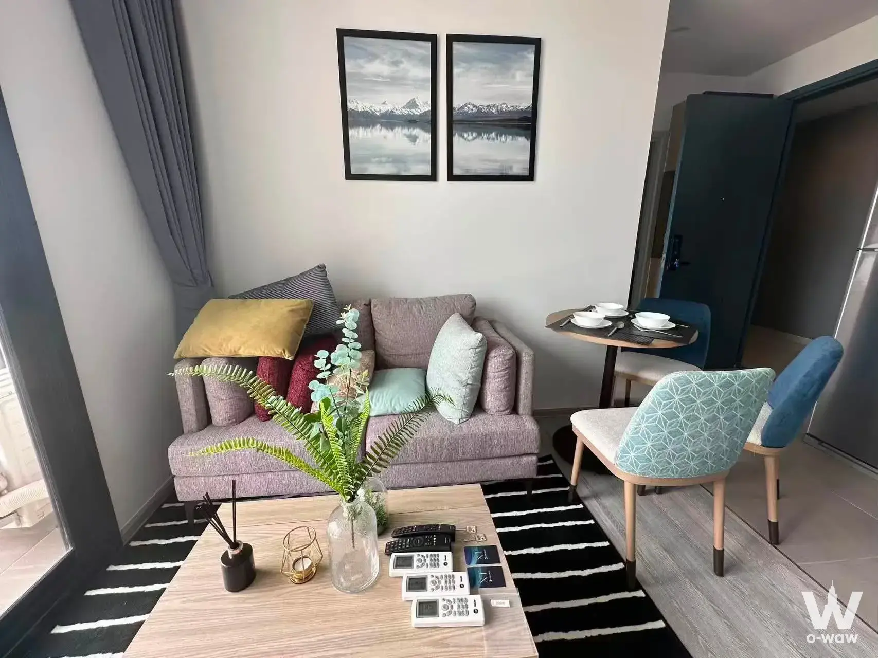 Living room at C Ekkamai Condominium with mauve sofa and dining nook
