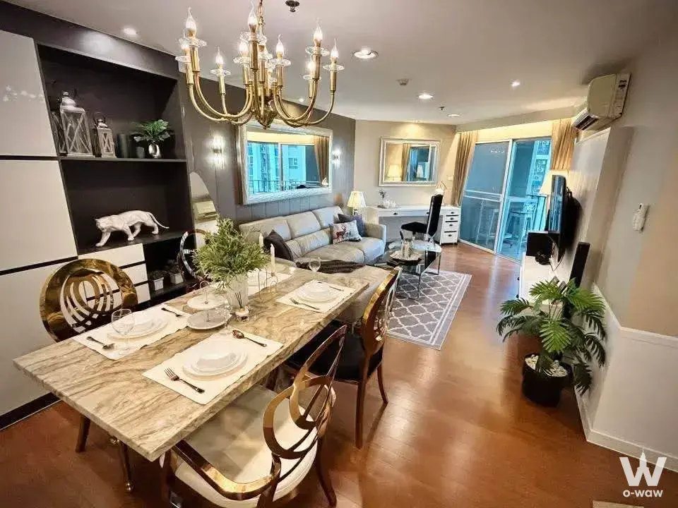 Dining area with marble table and brass chandelier in Belle Grand Rama 9 3-bed condo for rent