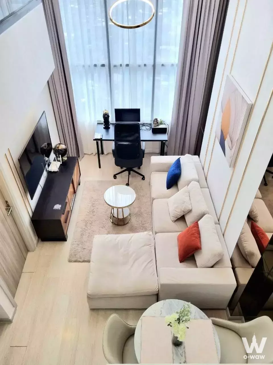 KnightsBridge Prime Sathon living room with high ceilings, L-shaped sofa, and floor-to-ceiling windows
