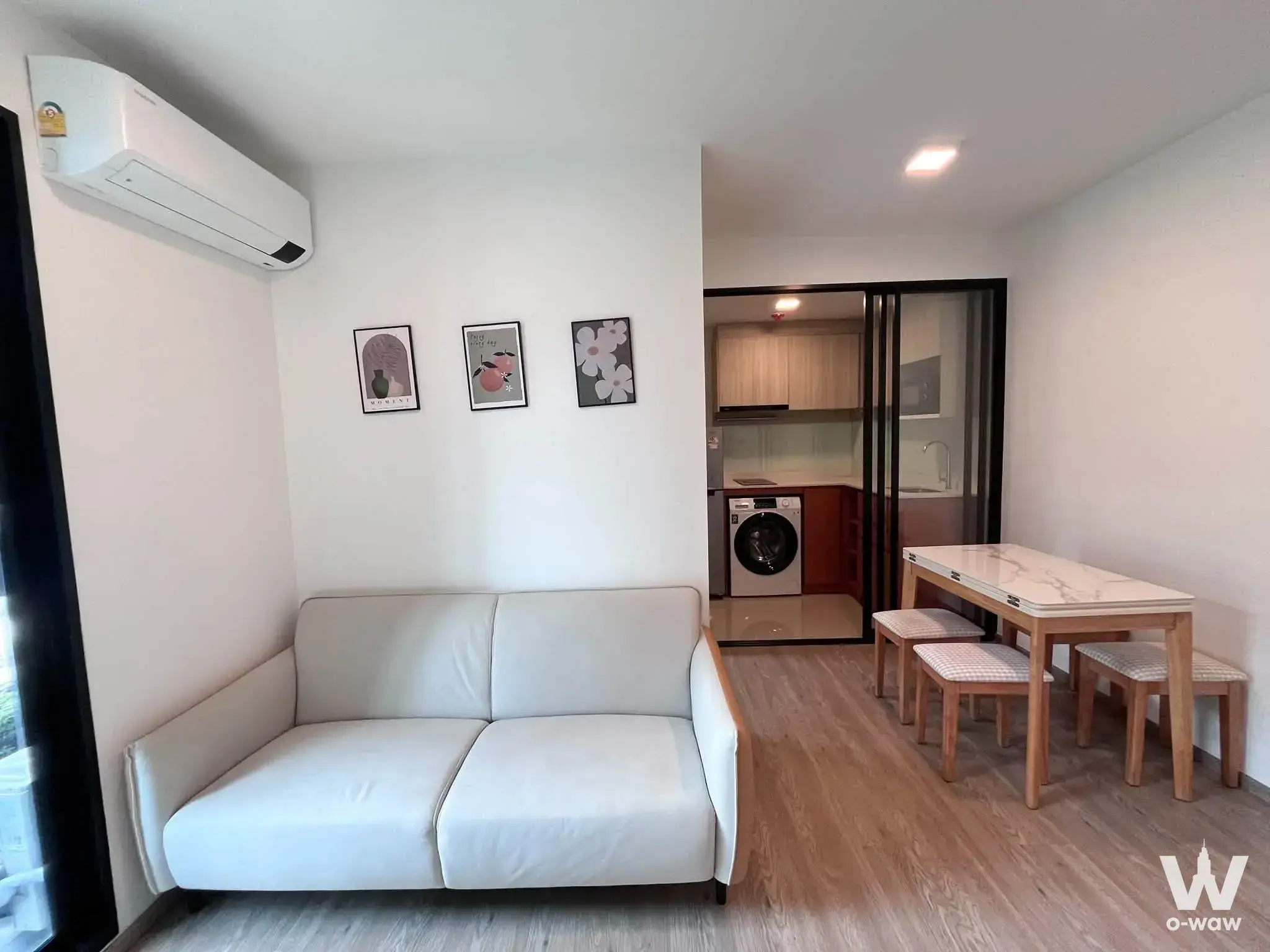 0-bed condo for rent in Chapter One All Ramintra Building B with light-grey sofa and marble dining table