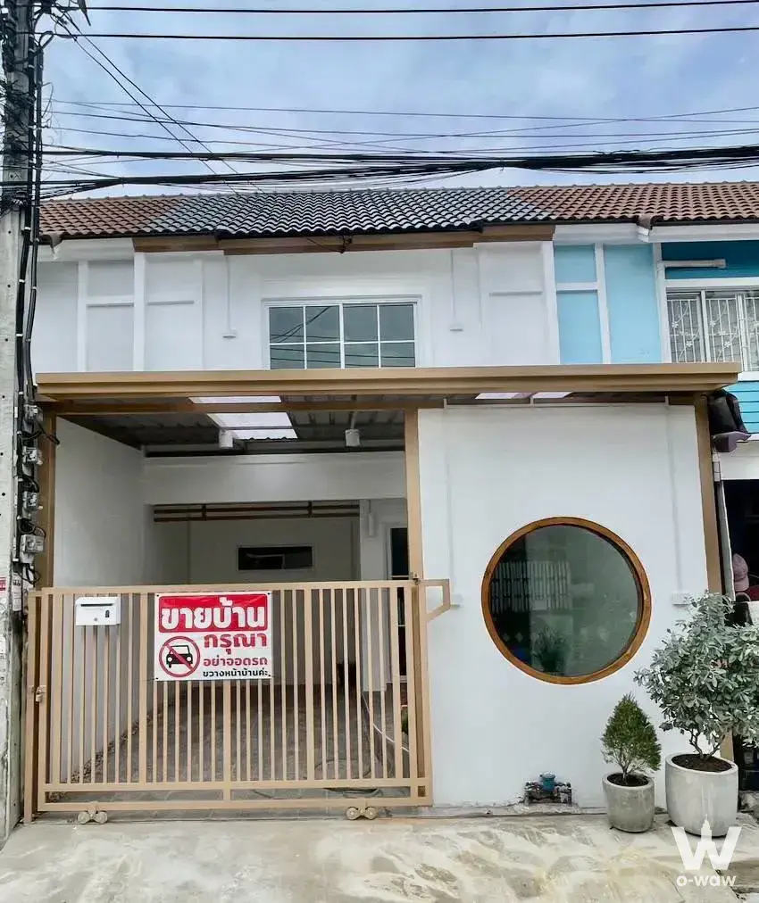 White stucco townhouse with terracotta roof and carport for sale in บ้านพฤกษา 45 บางใหญ่