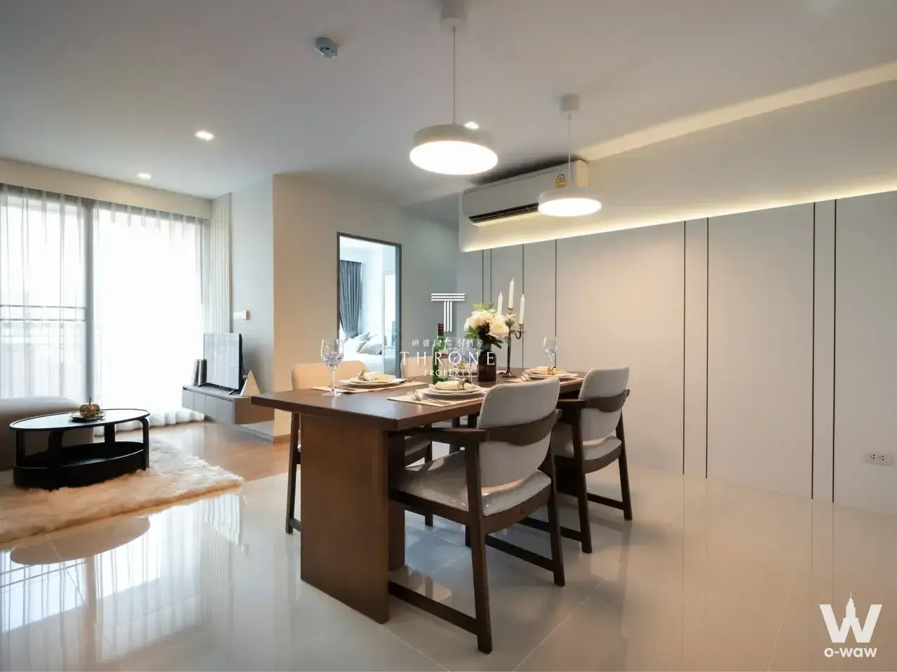 Dining and living area with pendant lights in a 2-bed condo for sale at art @ Thonglor