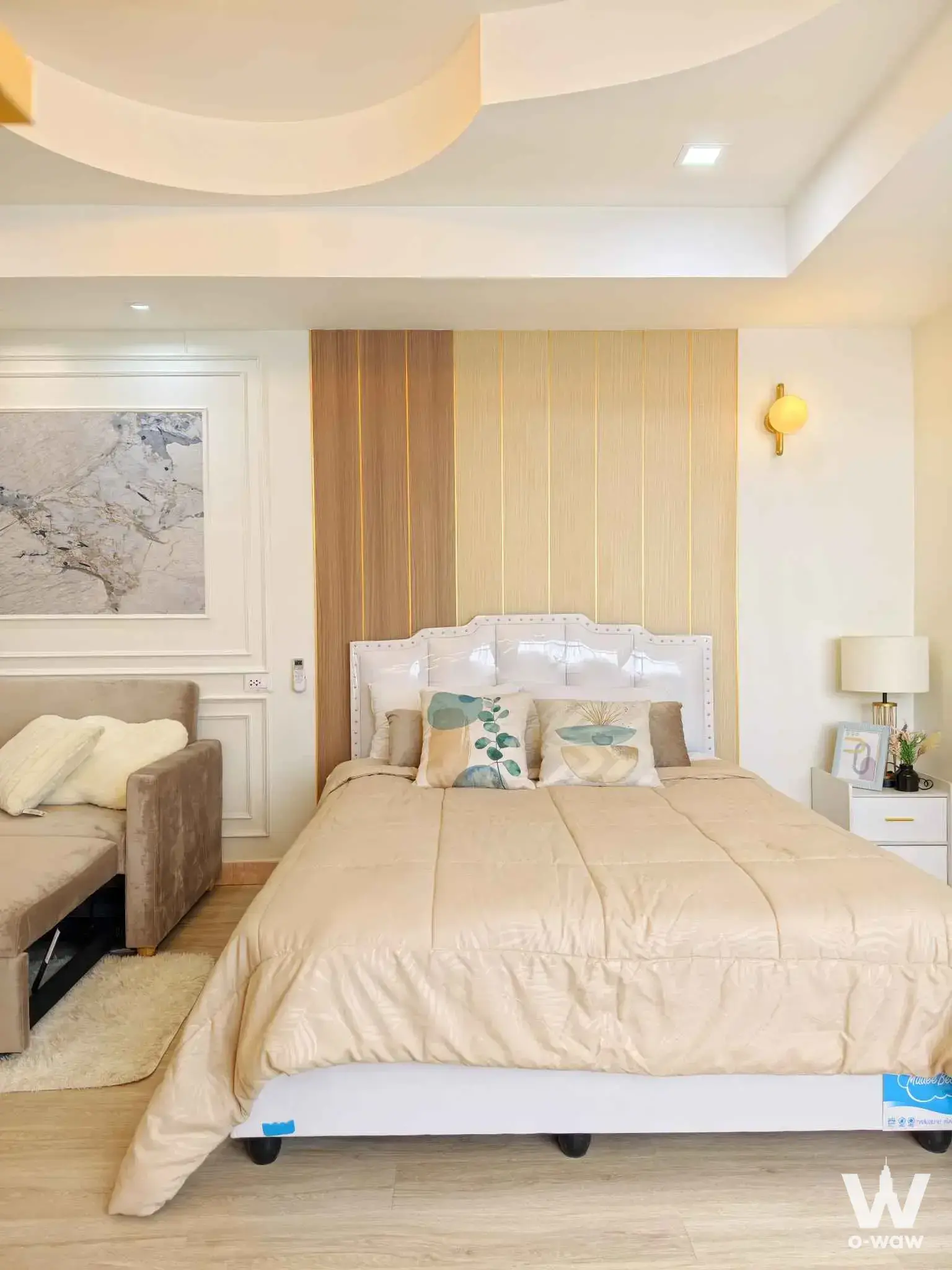 1-bed condo for sale in Udomsuk Tower with wood panel accent wall and gold accents