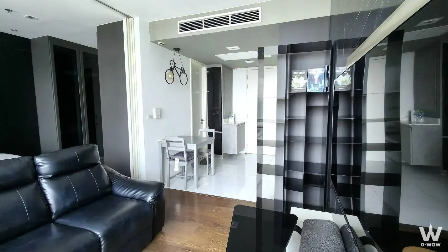 Modern living room for sale in Nara 9 by Eastern Star with black leather sofa and mirrored divider