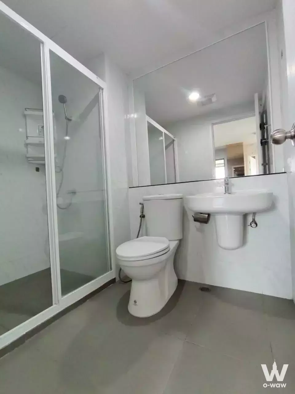 Compact bathroom in Polis Condo for sale with frameless mirror, glass shower enclosure, and grey matte floor tiles