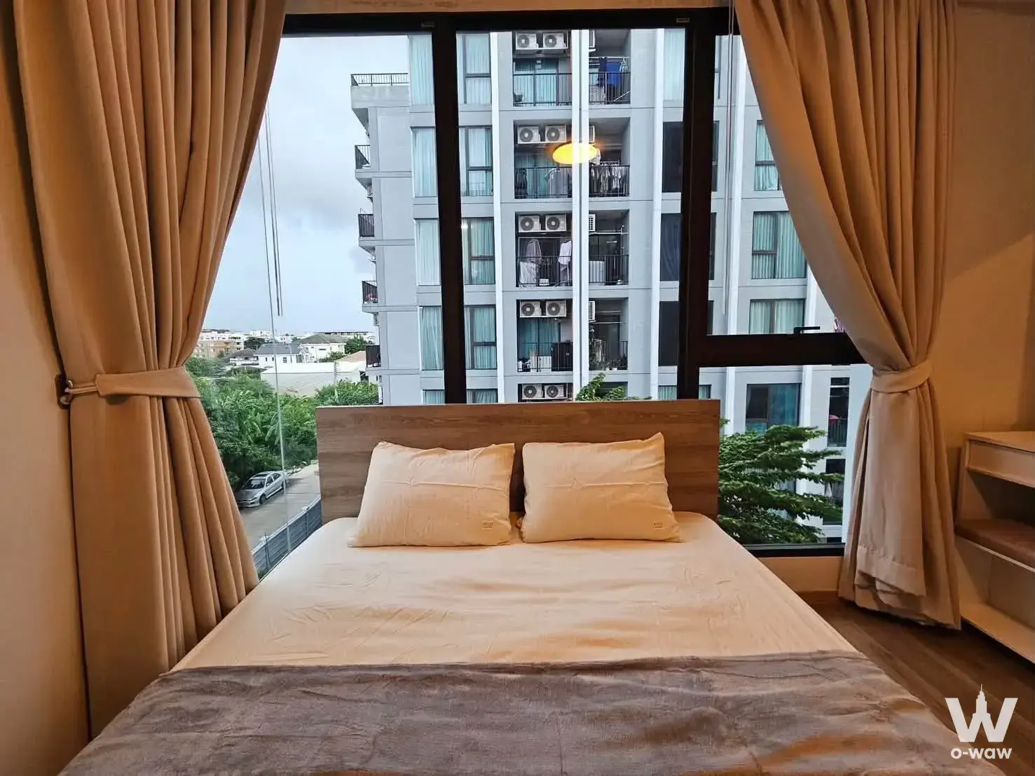 Minimalist bedroom in 1-bed condo for sale at Feel Condo Lat Phrao 122 with floor-to-ceiling windows