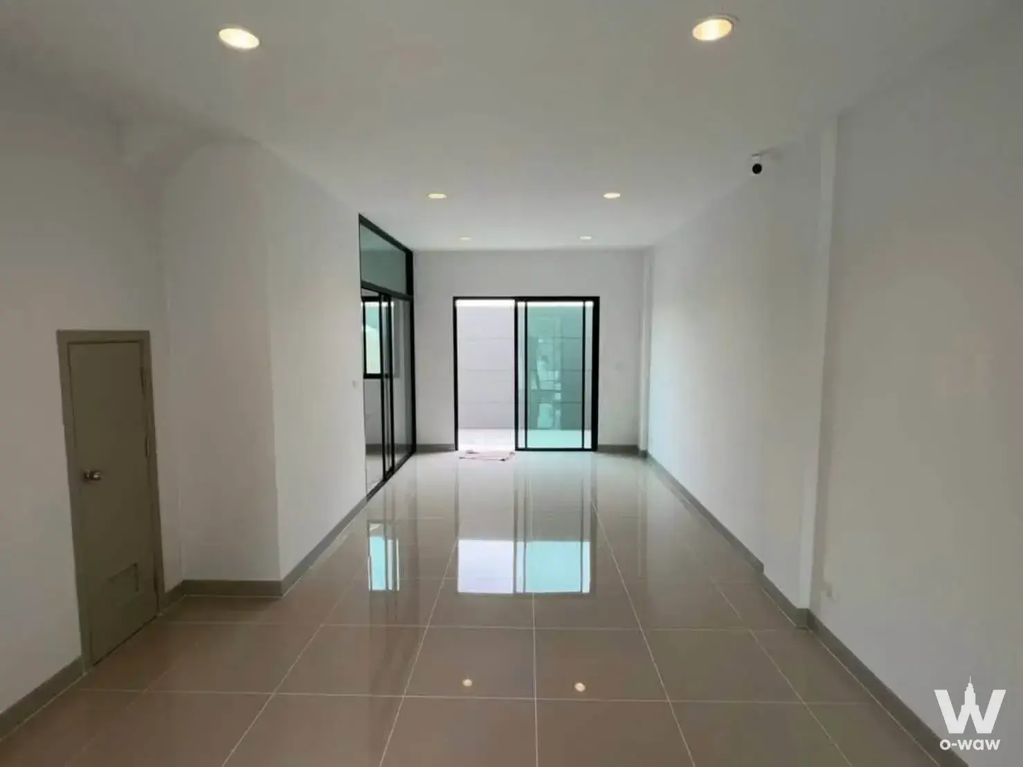 Empty commercial space in Premium Place with beige tile floors and glass partitions