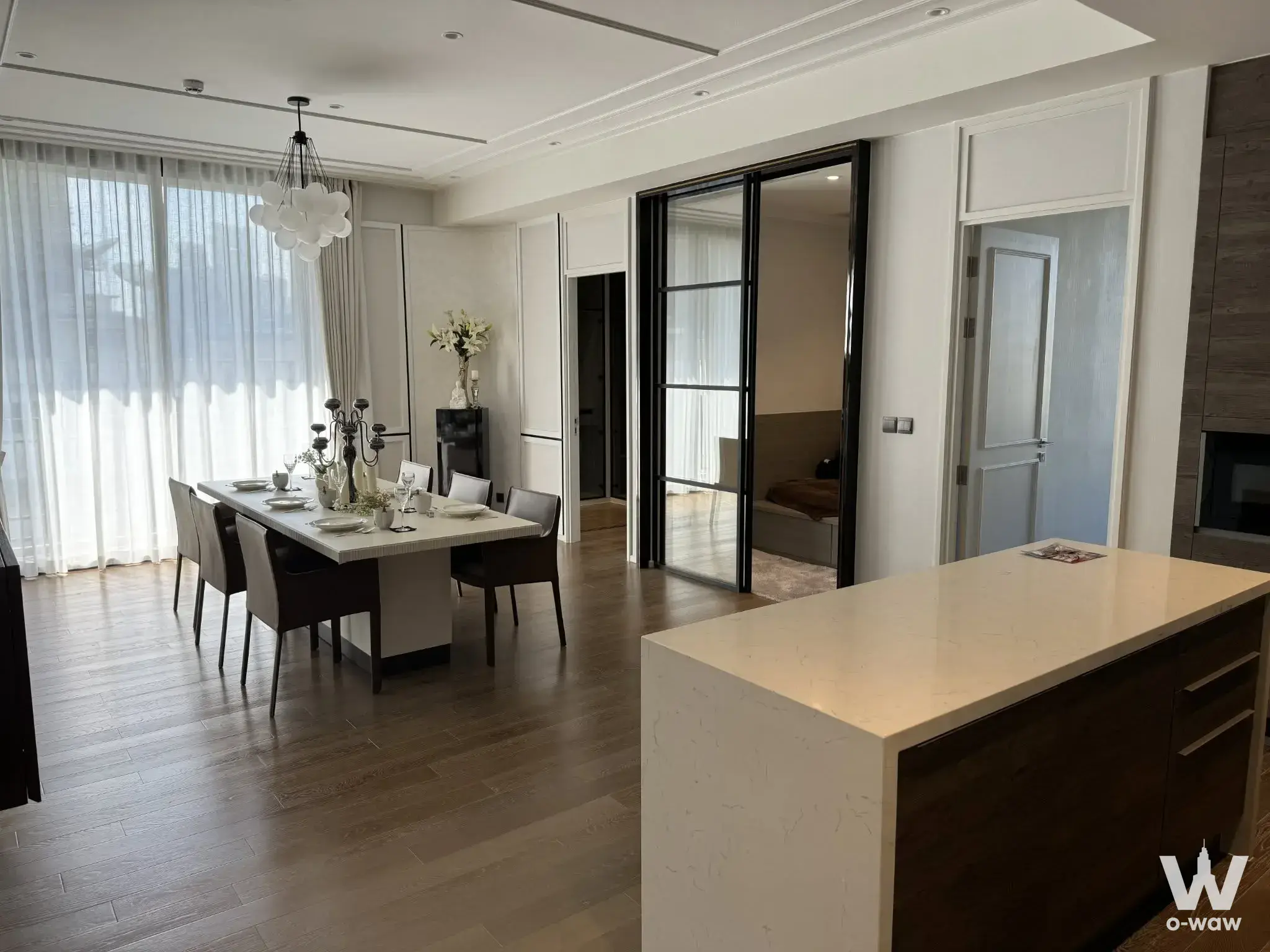 Luxury dining area with marble table and cloud chandelier in a 2-bed MUNIQ Lang Suan condo for rent