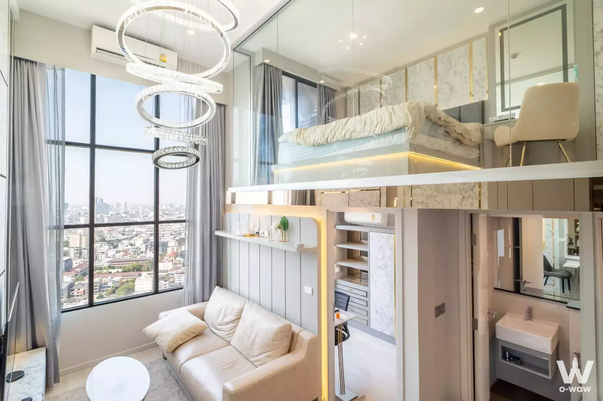 Loft-style studio in KnightsBridge Prime Sathon featuring mezzanine bed and city view
