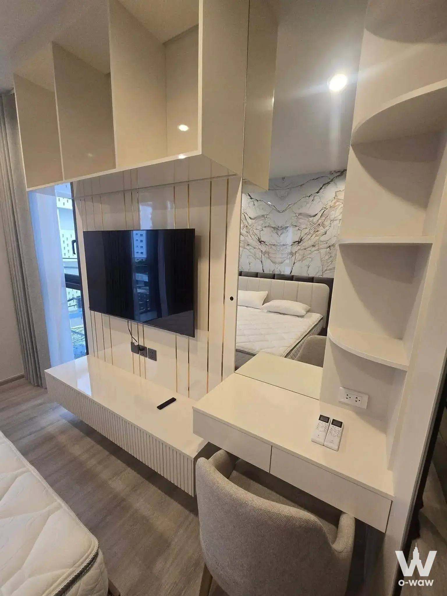 Furnished studio bedroom in PYNN Soonvijai condo with white glossy wall unit and city view