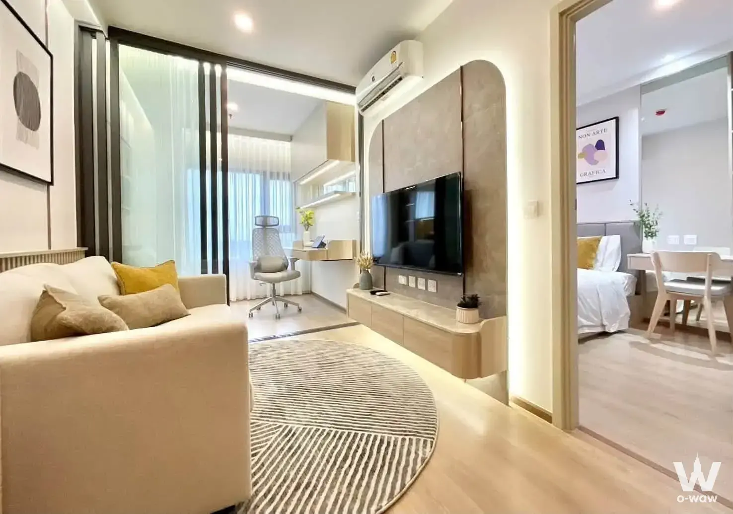 Living room with arched stone feature wall in Life Rama 4 Asoke condo