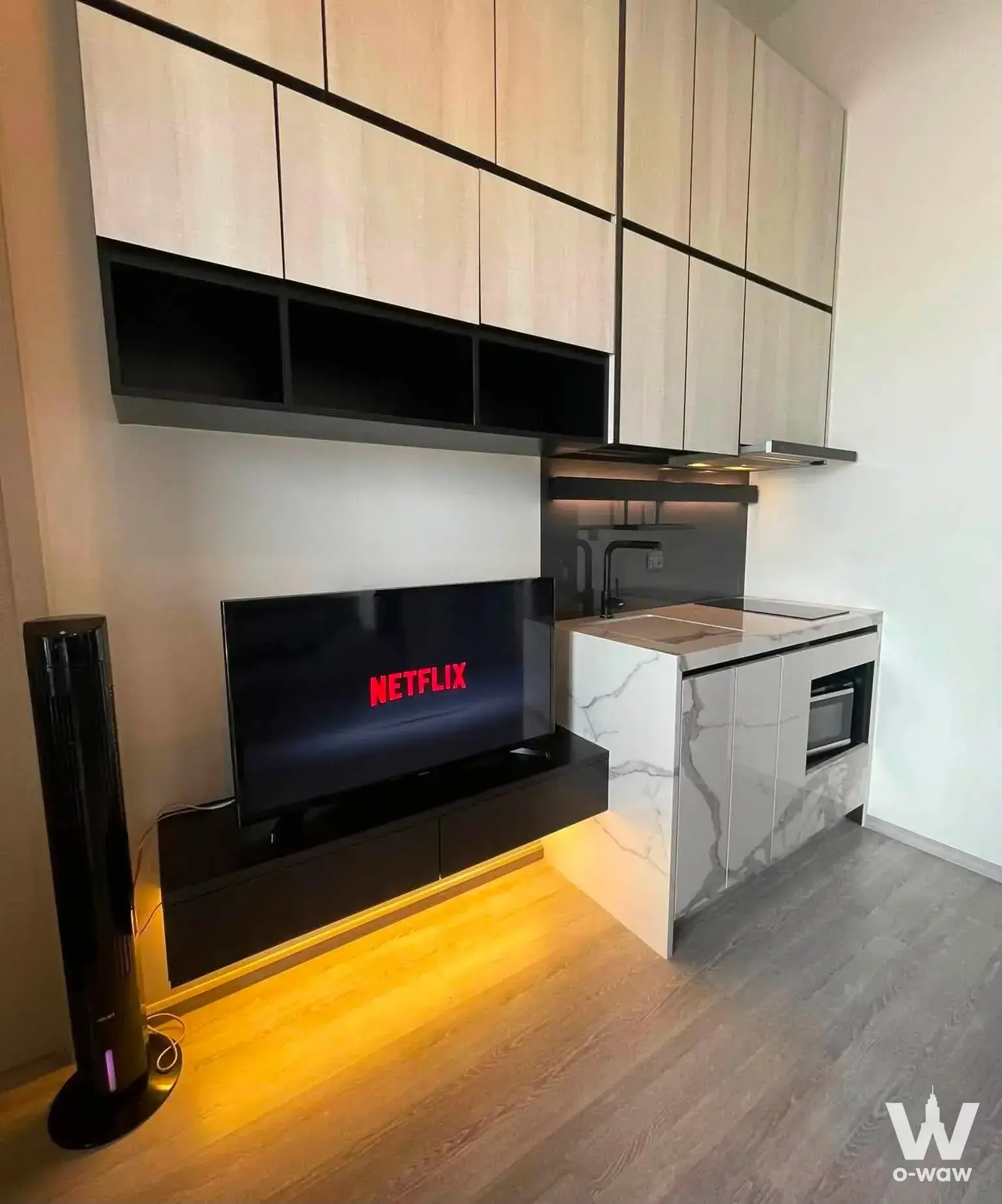 Living space in THE LINE Sukhumvit 71 with compact kitchenette and warm LED lighting