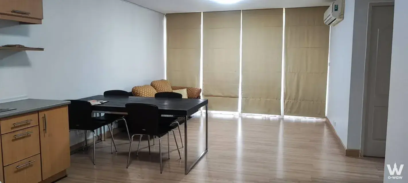 2-bed condo for sale in Prima Srinagarindra Condo with light wood floors, dining set, and full window blinds