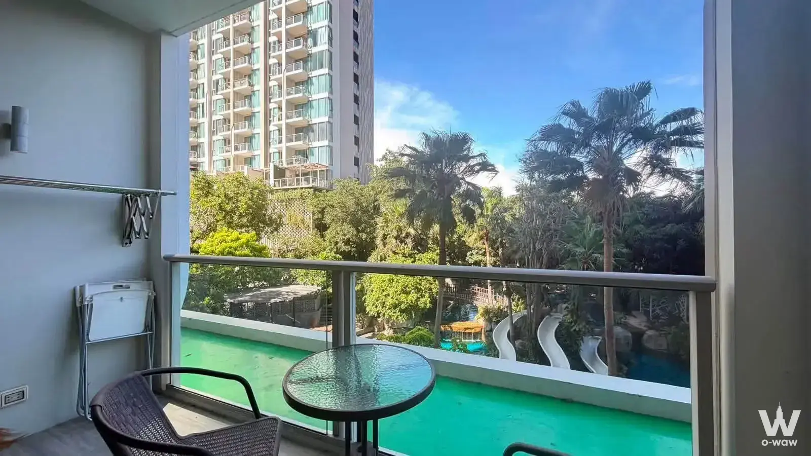The Riviera Wongamat Beach 1-bed condo balcony with rattan chair and pool view