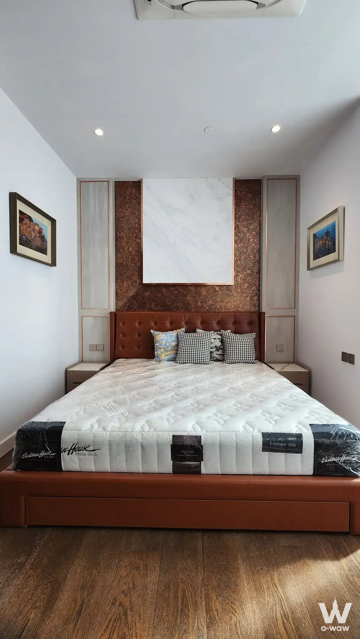 Luxury bedroom in Supalai Icon Sathorn condo featuring marble feature wall and leather headboard