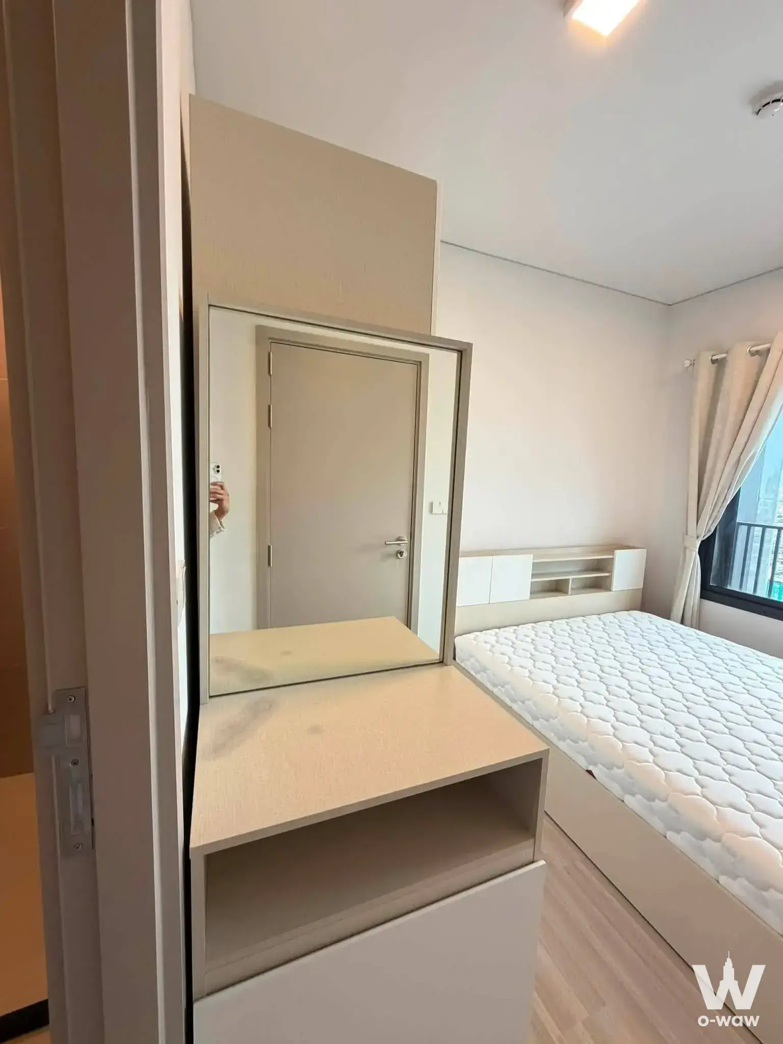 Light wood vanity and platform bed with balcony view in 1-bed condo for rent at QUINTARA MHy'DEN PHO NIMIT