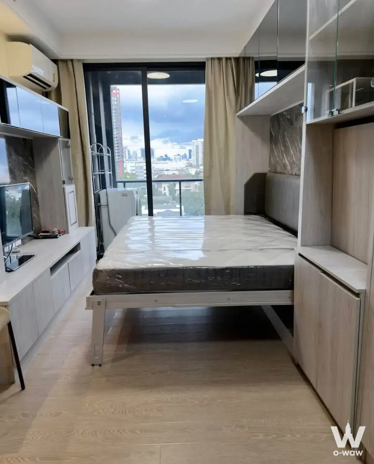 1-bed condo for rent in Regal Condo Sathon featuring a furnished bedroom with city skyline view