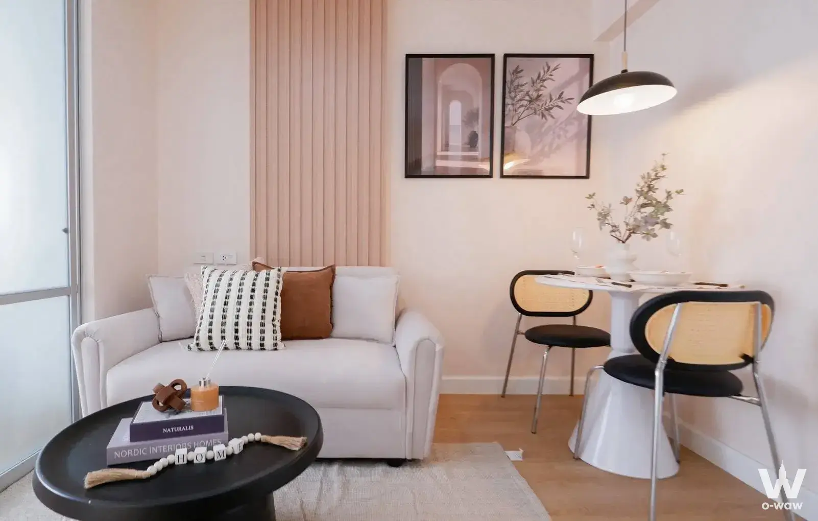 Staged 1-bed condo for sale in Lumpini Ville Ramintra-Laksi featuring pink wood paneling and art prints