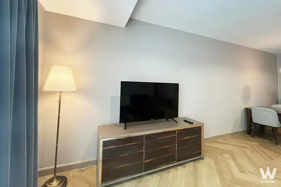 Living room corner in 59 Heritage townhouse featuring herringbone floors and dark walnut sideboard