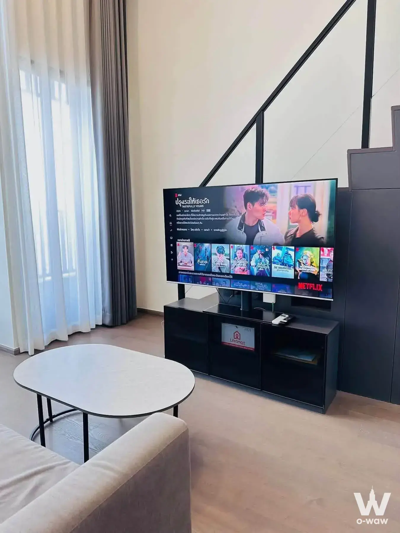 Modern 1-bed condo living room in Park Origin Chula-Samyan with Netflix TV and open loft staircase