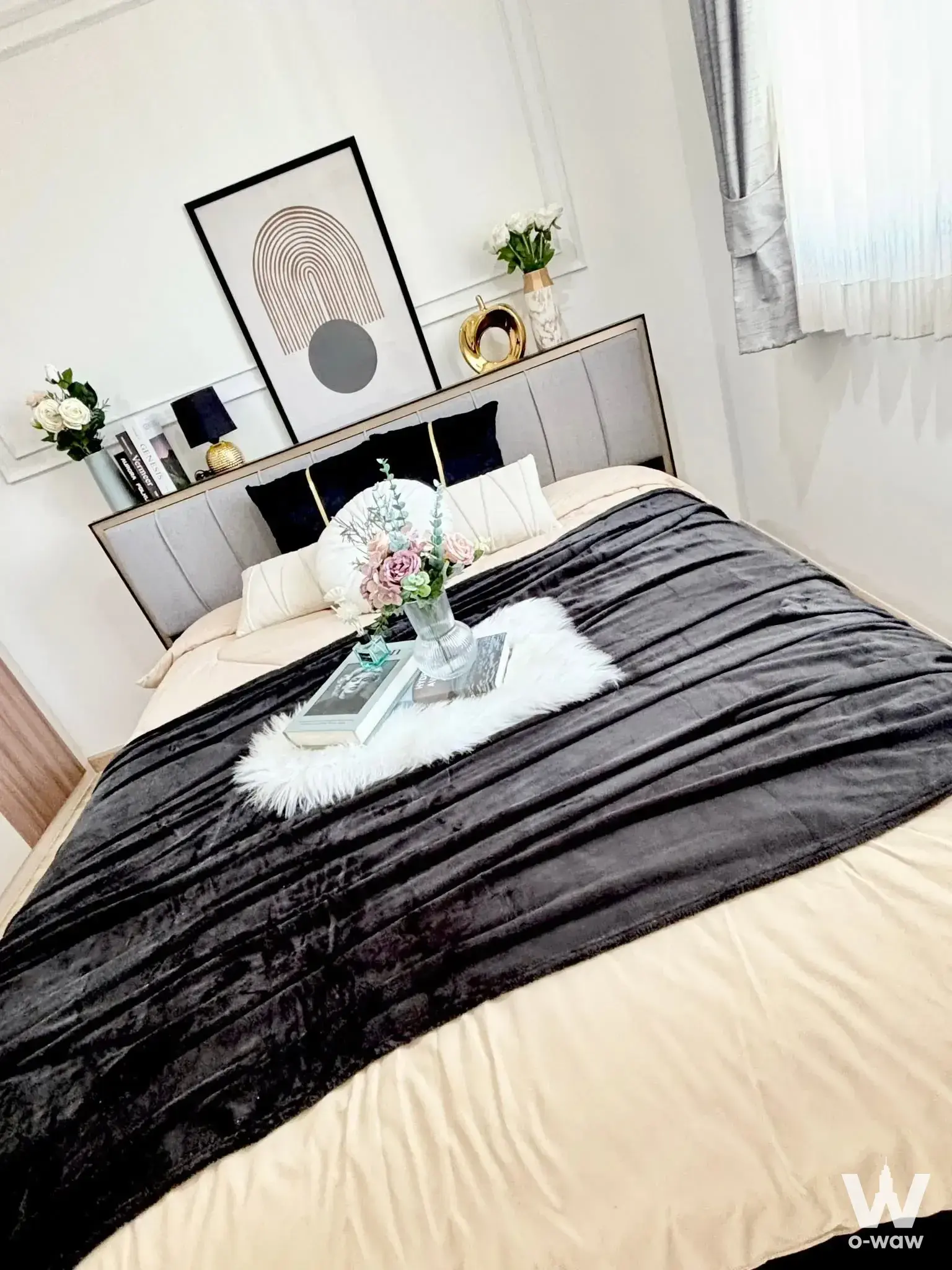 Modern bedroom in Lumpini Mega City Bang Na condo with king bed and gold-trimmed headboard
