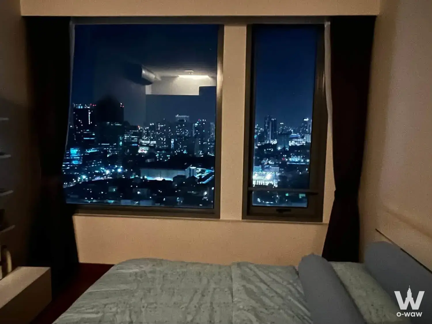 1-bed condo for rent in Vantage Condominium bedroom with night city skyline view through large window