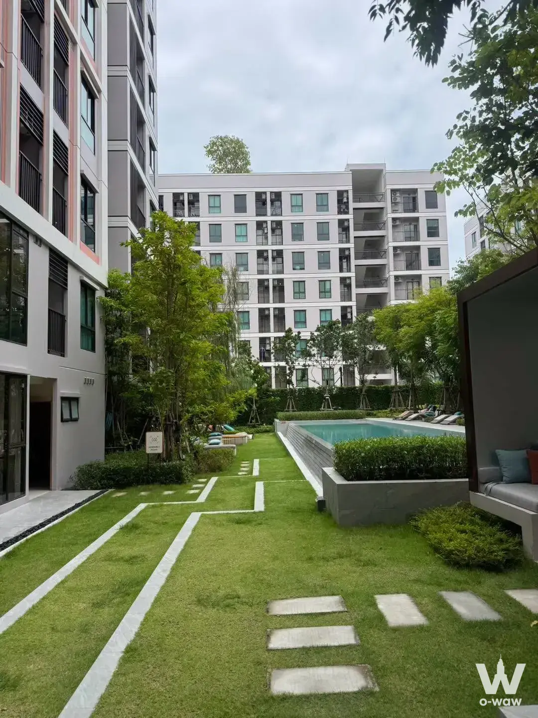 Outdoor pool amenity in GOOD DAY Sukhumvit 93 condo with turquoise water and landscaped garden