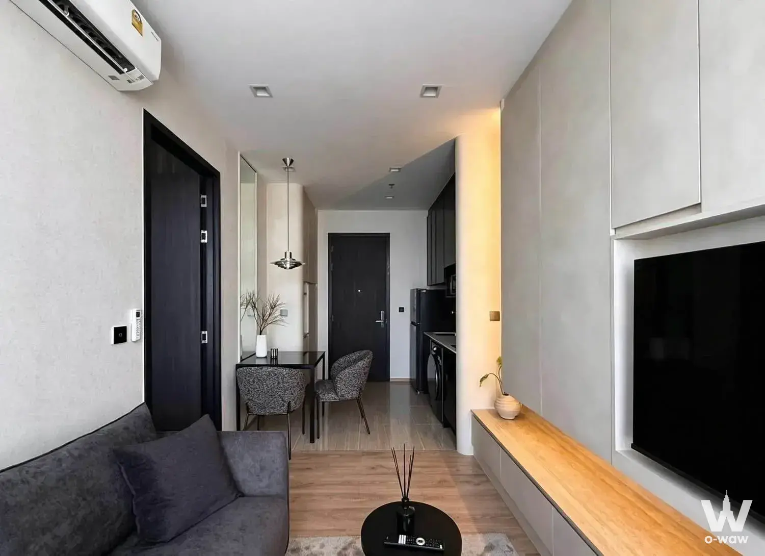 1-bed condo for rent in Noble Around Ari with TV niche, amber LED lighting, and glass-top dining table