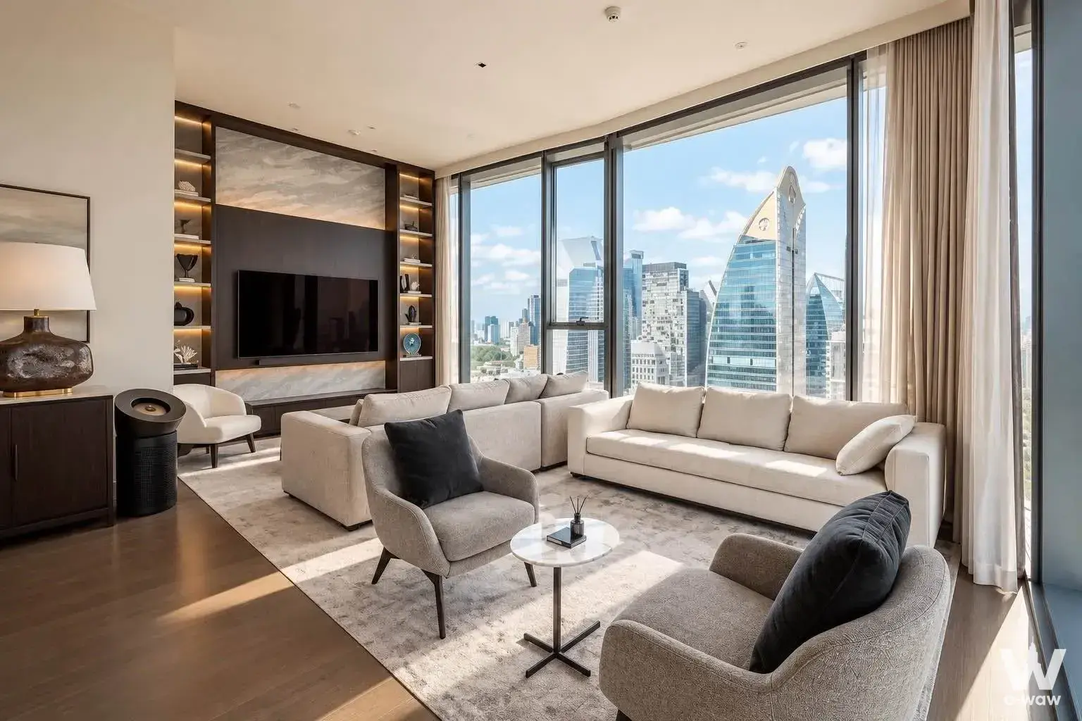 Living room in SCOPE Langsuan 2-bed condo with cream sectional and corner window city view